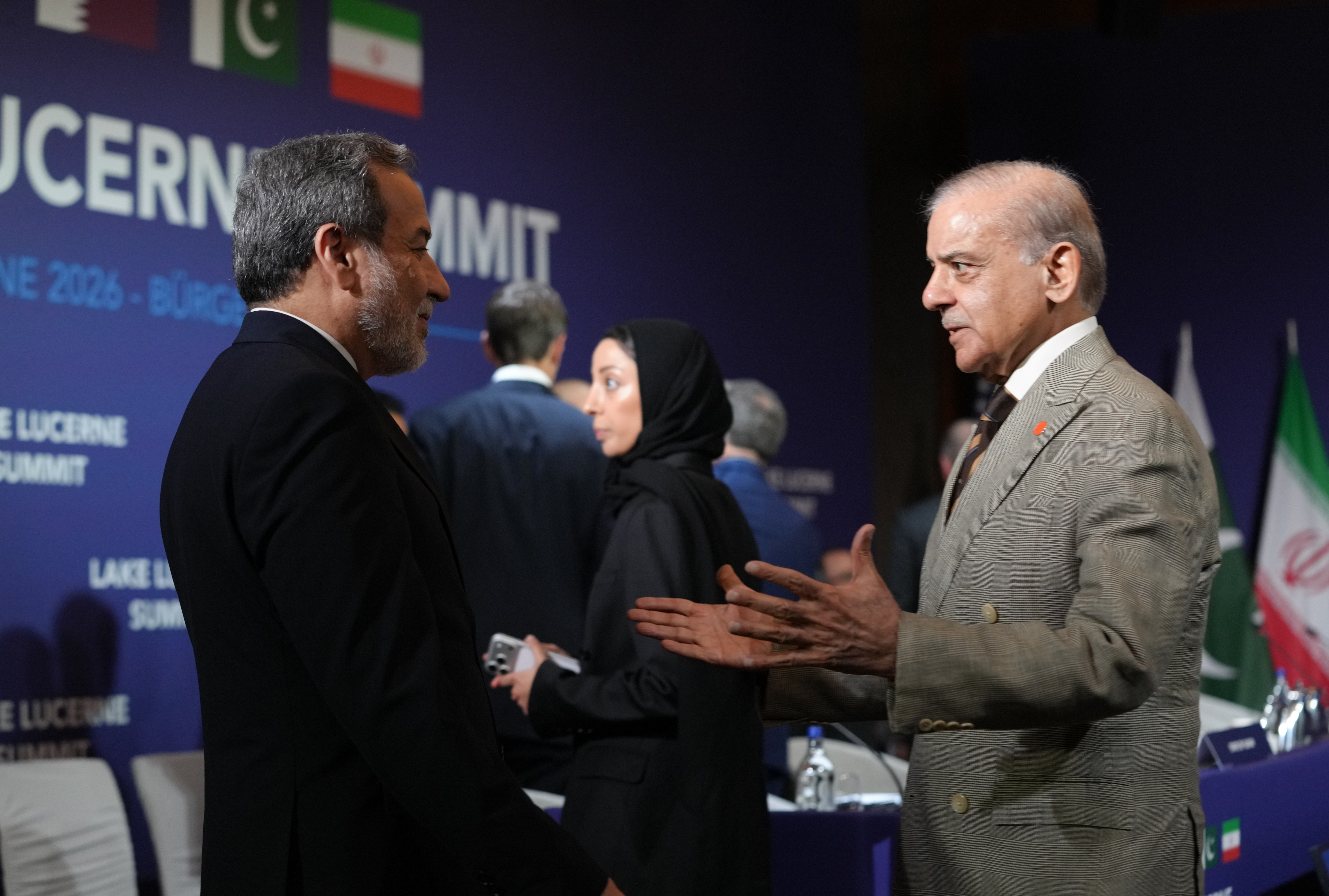 STANSSTAD, SWITZERLAND - JUNE 21: Iran's Foreign Minister Abbas Araqchi and Pakistan's Prime Minister Shehbaz Sharif greet each other before the start of a quadrilateral meeting between the U.S., Iran, Pakistan, and Qatar at the Lake Lucerne Summit, aimed at advancing a deal to end the Middle East conflict at the Buergenstock Resort, Lake Lucerne on June 21, 2026 near Stansstad, Switzerland. US Vice President JD Vance is visiting Switzerland for negotiations with Iran to end the war and open the Strait of Hormuz that have been delayed by Israeli strikes in Lebanon. (Photo by Nathan Howard-Pool/Getty Images)
