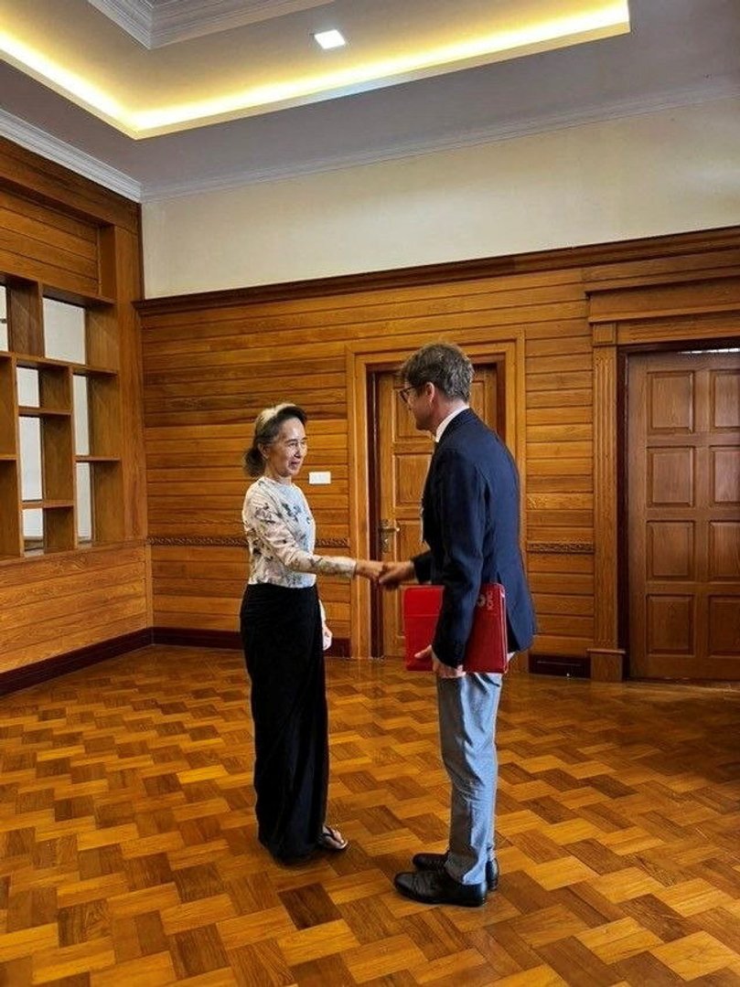 Myanmar's detained former leader Aung San Suu Kyi shakes hands with Arnaud de Baecque, the International Committee of the Red Cross (ICRC) resident representative and head of delegation to Myanmar, in Naypyidaw, Myanmar, August 3, 2026. Khine Khine Soe, Myanmar government spokesperson/Handout via REUTERS.