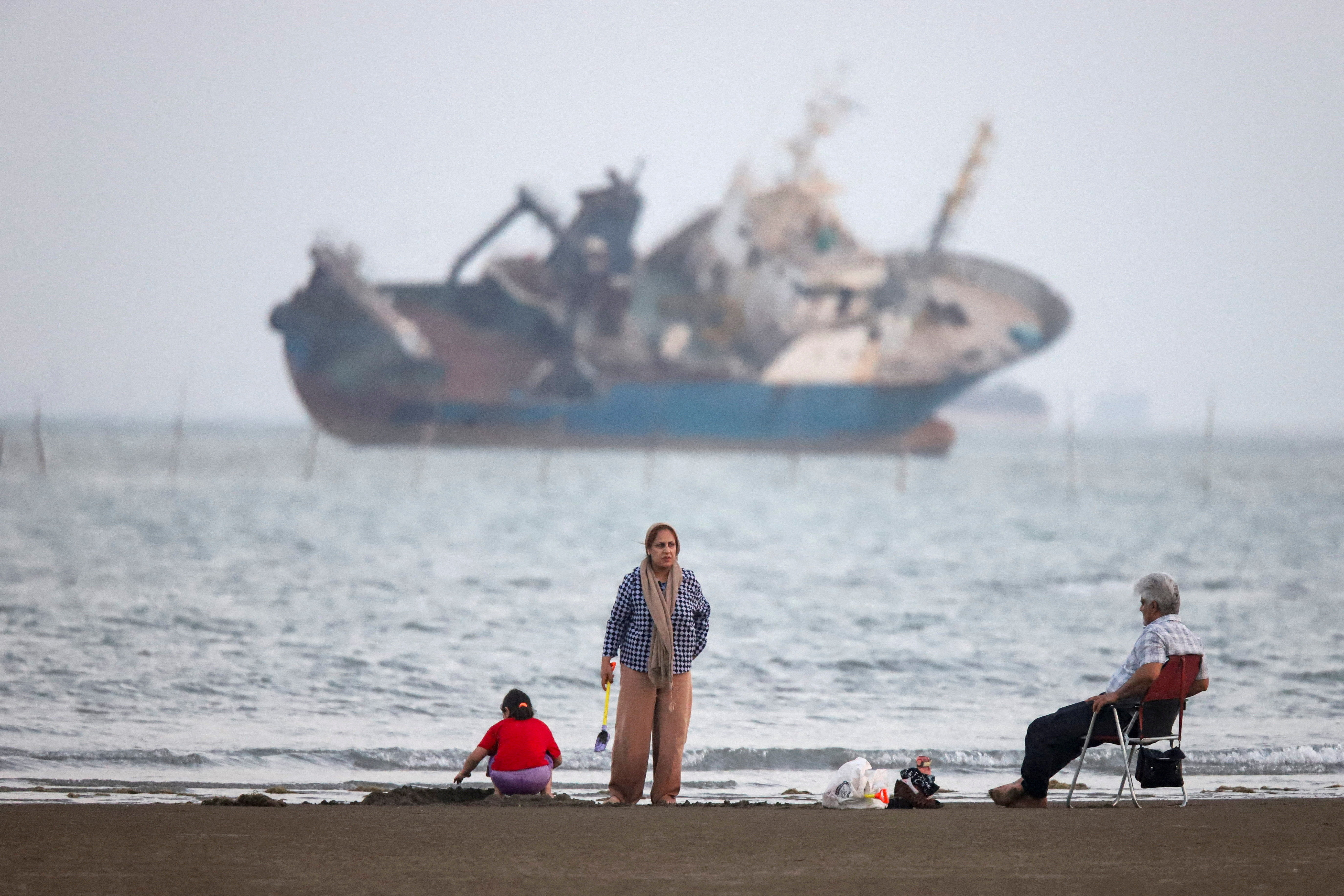 FILE PHOTO: People gather on a beach, as a vessel in the Strait of Hormuz is visible, near the beach of Bandar Abbas, Iran, May 31, 2026. Amirhosein Khorgooi/ISNA/WANA (West Asia News Agency) via REUTERS ATTENTION EDITORS - THIS PICTURE WAS PROVIDED BY A THIRD PARTY ATTENTION EDITORS - THIS PICTURE WAS PROVIDED BY A THIRD PARTY. ISRAEL OUT. NO COMMERCIAL OR EDITORIAL SALES IN ISRAEL. NO ACCESS FOR ISRAELI MEDIA. NO USE BBC PERSIAN. NO USE VOA PERSIAN. NO USE MANOTO. NO USE IRAN INTERNATIONAL. NO USE RADIO FARDA. DIGITAL: NO USE BBC PERSIAN. NO USE VOA PERSIAN. NO USE MANOTO. NO USE IRAN INTERNATIONAL. NO USE RADIO FARDA./File Photo