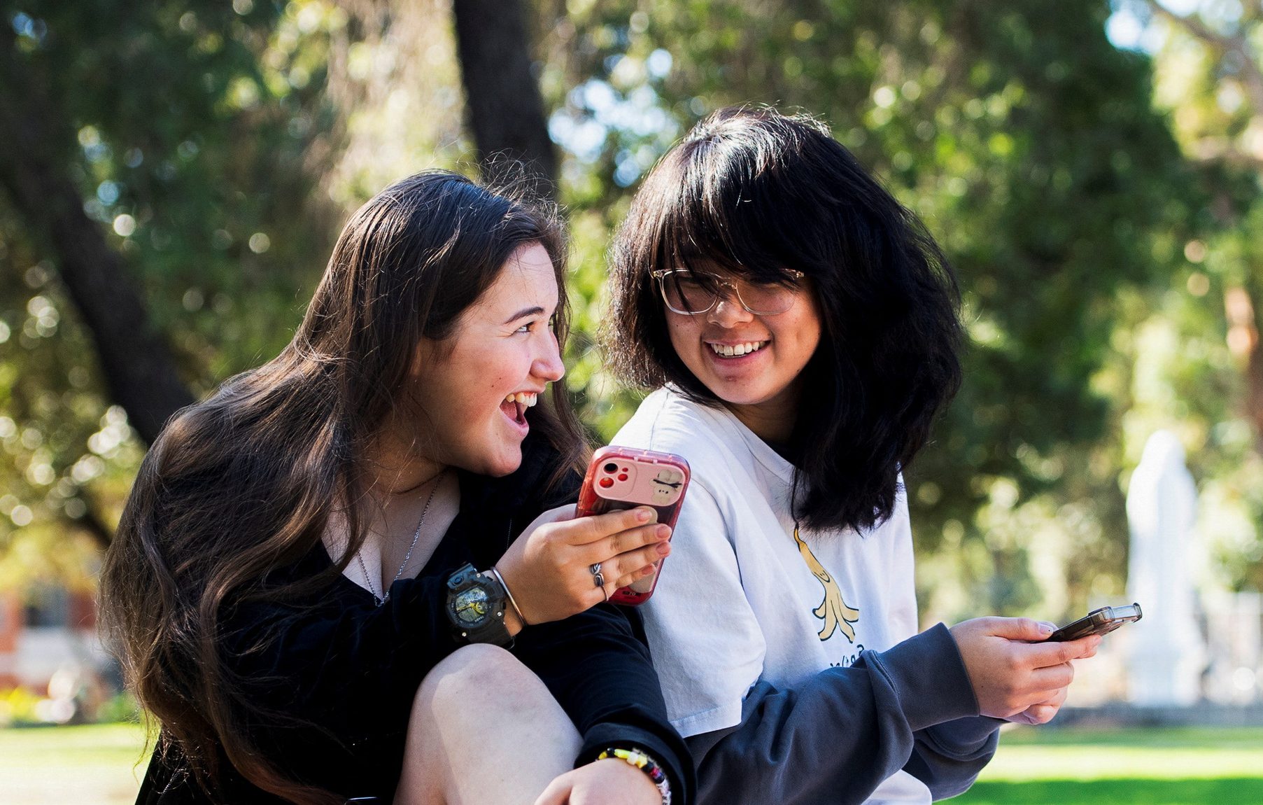 Annie Wang, 15, and Novva Tolson, 15, pose as they scroll through their social media feeds, in Sydney, Australia July 14, 2026. REUTERS/Jeremy Piper