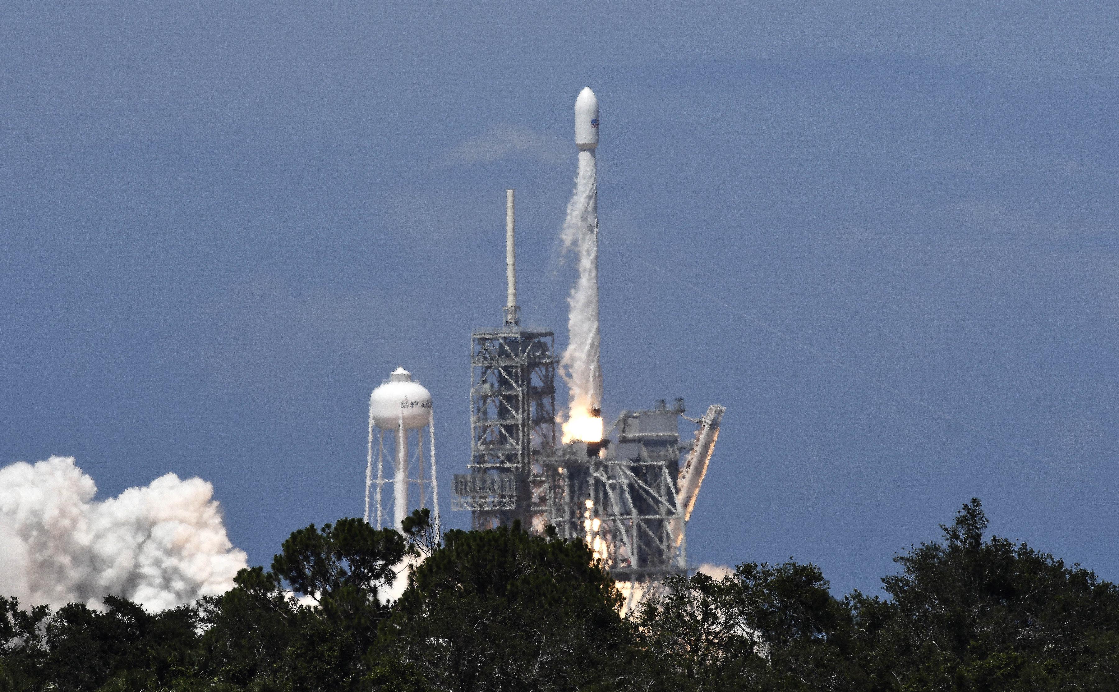 A SpaceX Falcon 9 rocket lifts off from Kennedy Space Center