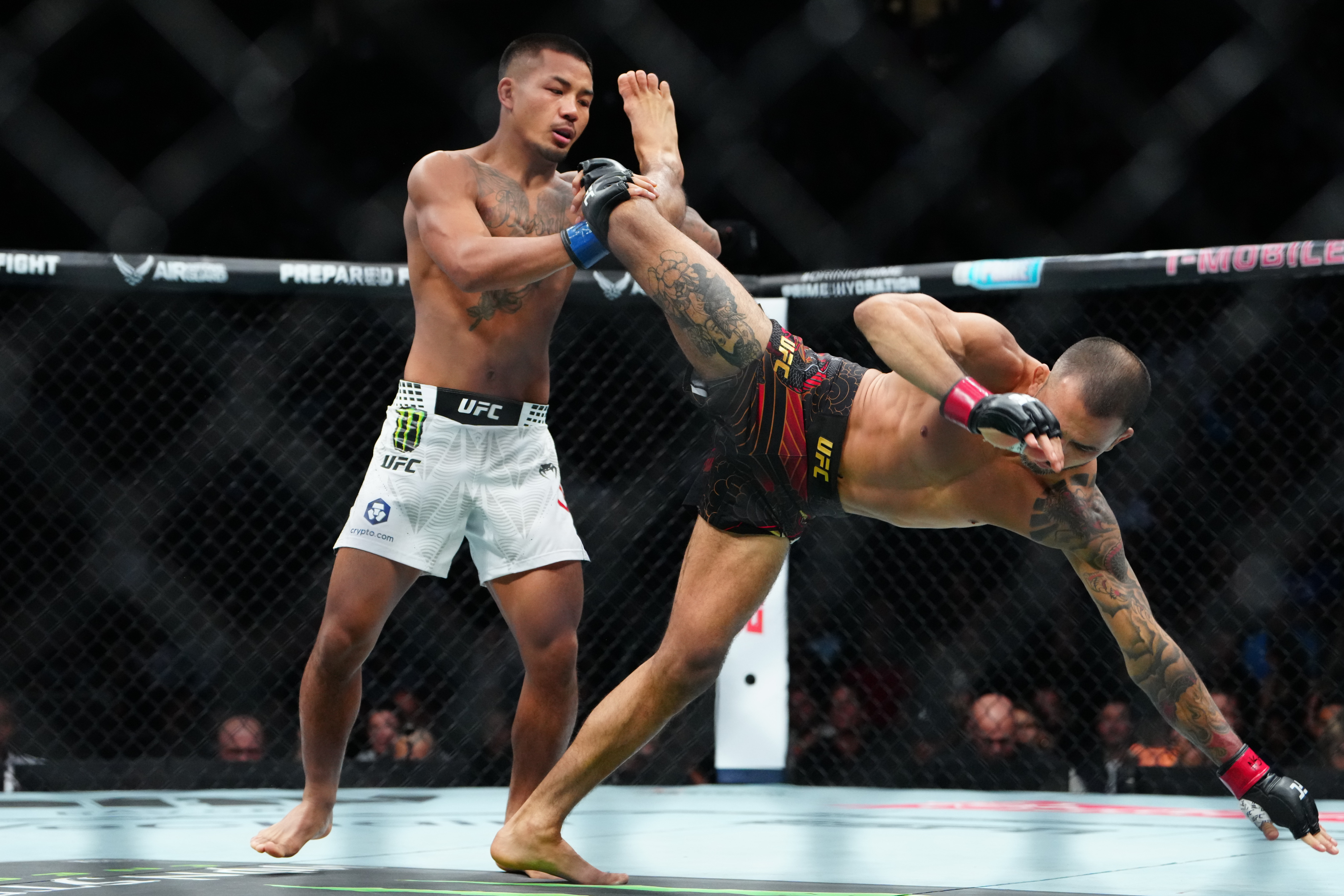 Dec 6, 2025; Las Vegas, Nevada, UNITED STATES; Alexandre Pantoja (red gloves) fights Joshua Van (blue gloves) during UFC 323 at T-Mobile Arena. Mandatory Credit: Stephen R. Sylvanie-Imagn Images