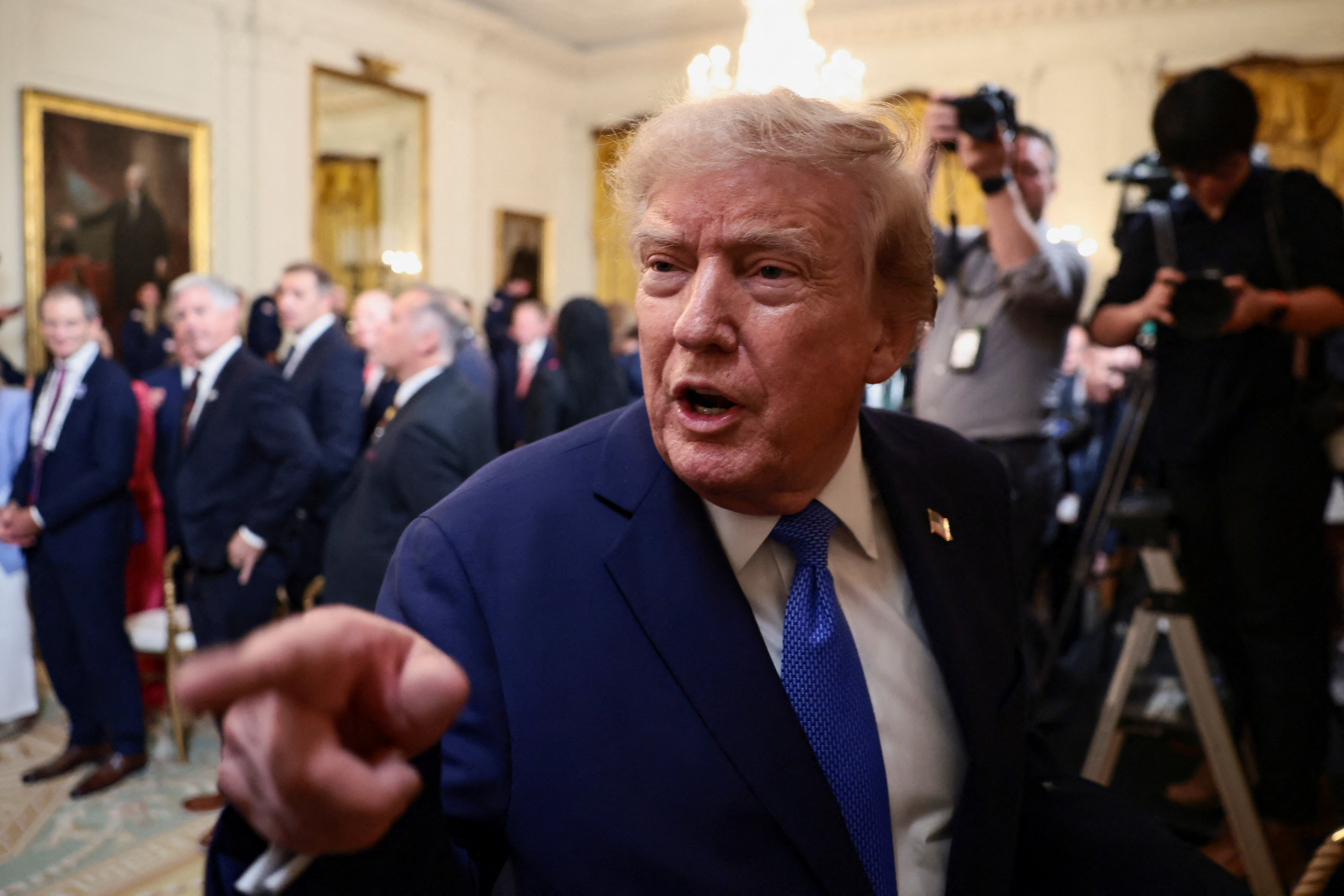 US President Donald Trump points a finger as he speaks.