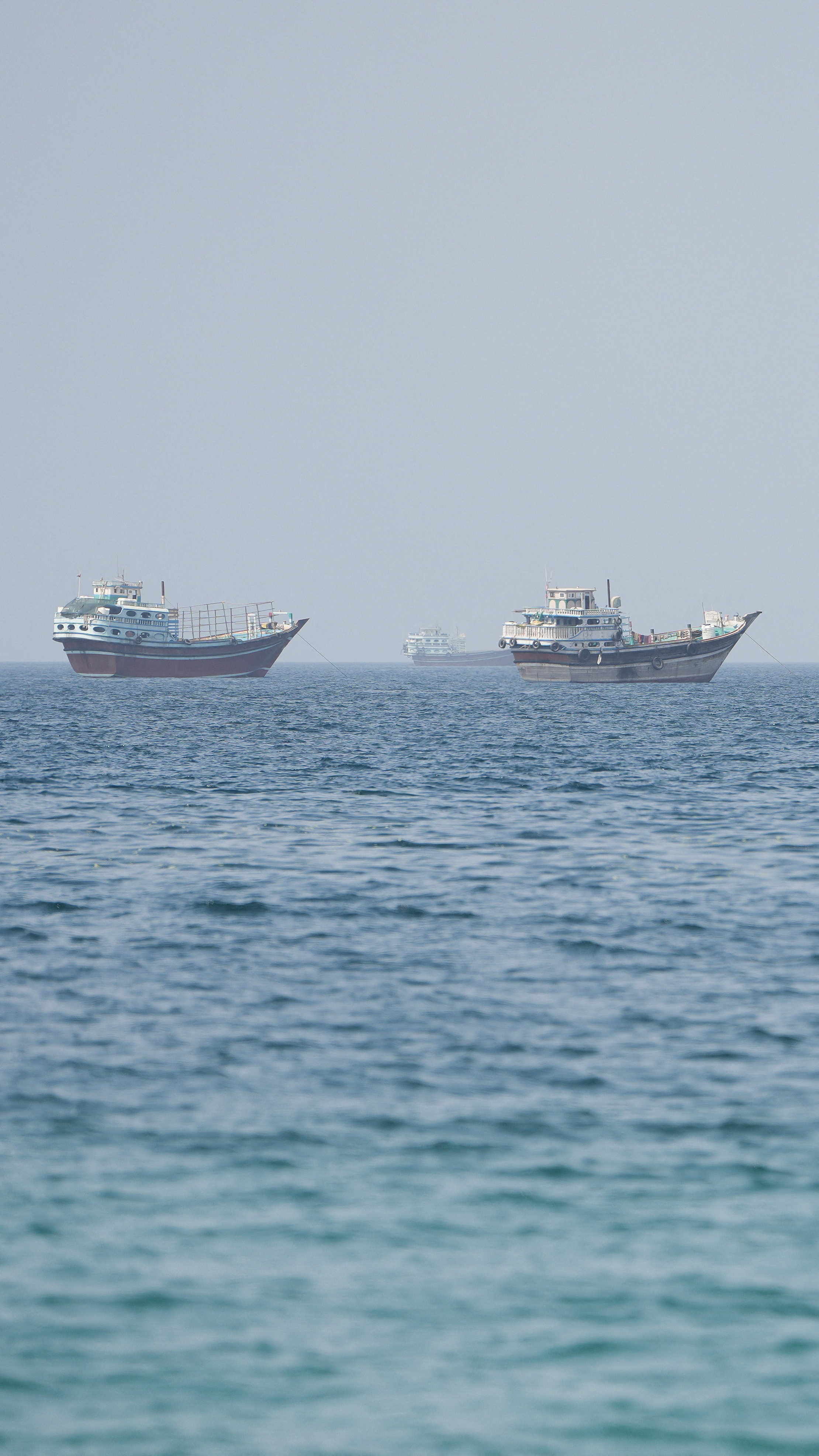 Vessels near the Strait of Hormuz, as seen from Musandam, Oman, August 6, 2026. REUTERS/Stringer