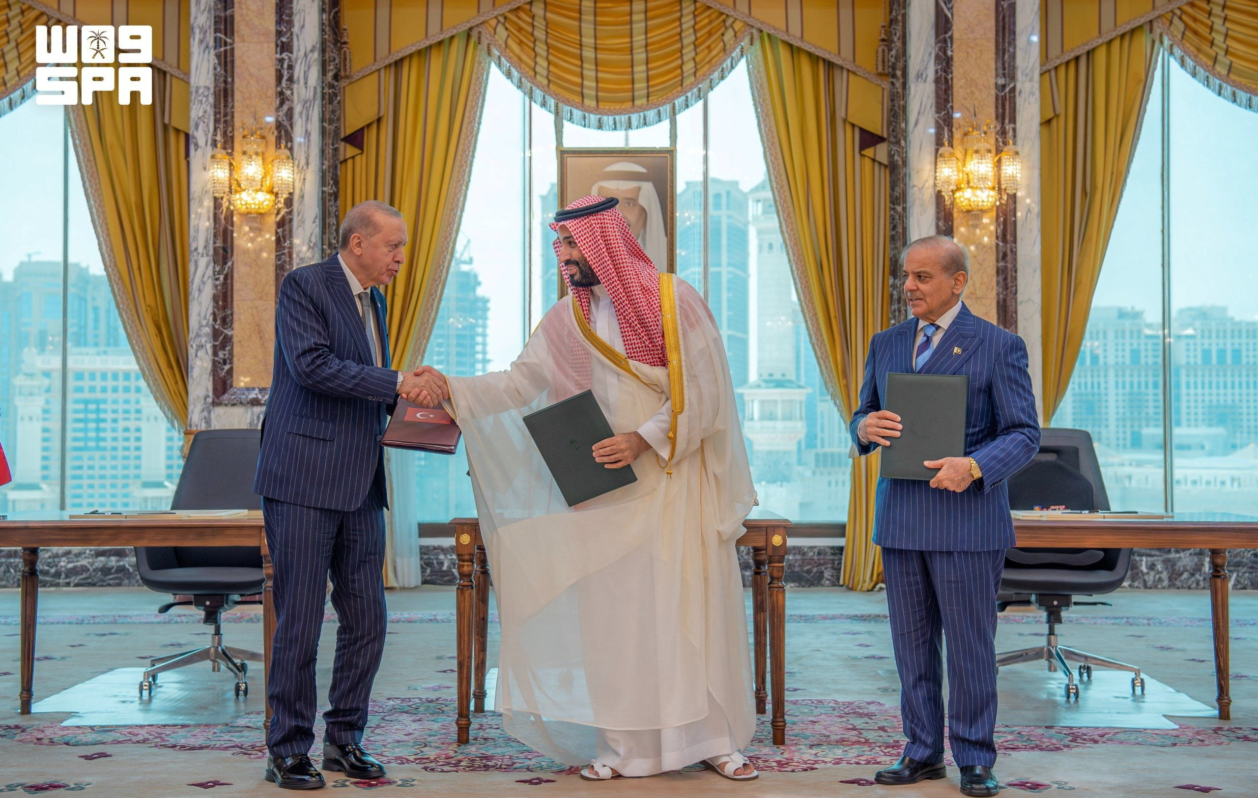 Turkish President Tayyip Erdogan shakes hands with Saudi Crown Prince Mohammed bin Salman, next to Pakistan's Prime Minister Shehbaz Sharif, after signing a joint defence agreement in Mecca, Saudi Arabia, August 7, 2026. Saudi Press Agency/Handout via REUTERS ATTENTION EDITORS - THIS PICTURE WAS PROVIDED BY A THIRD PARTY. WATERMARK FROM SOURCE