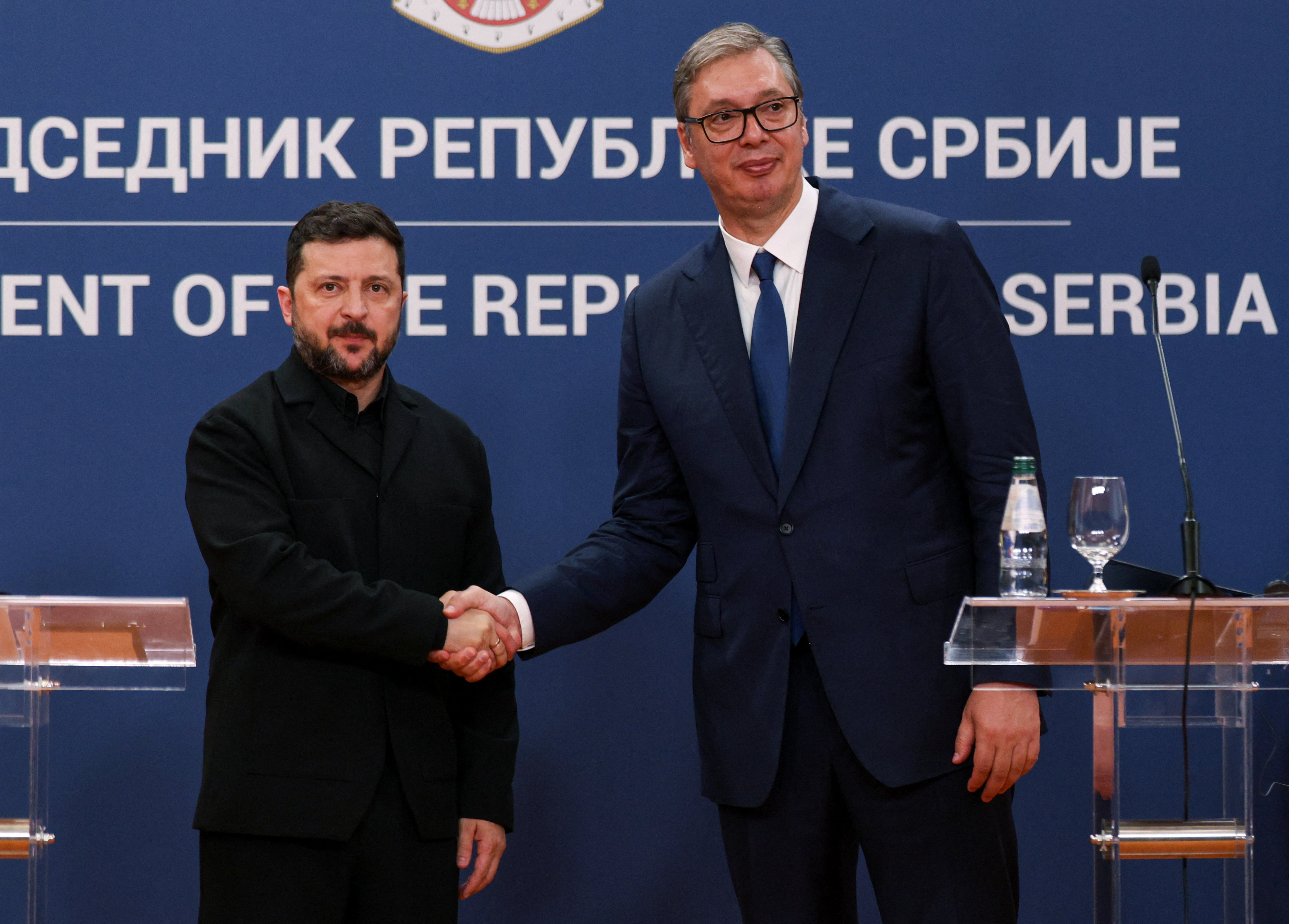 Serbian President Aleksandar Vucic and Ukrainian President Volodymyr Zelenskiy shake hands at the end of a press conference during Zelenskiy's visit to Belgrade, Serbia, August 8, 2026. REUTERS/Marko Djurica