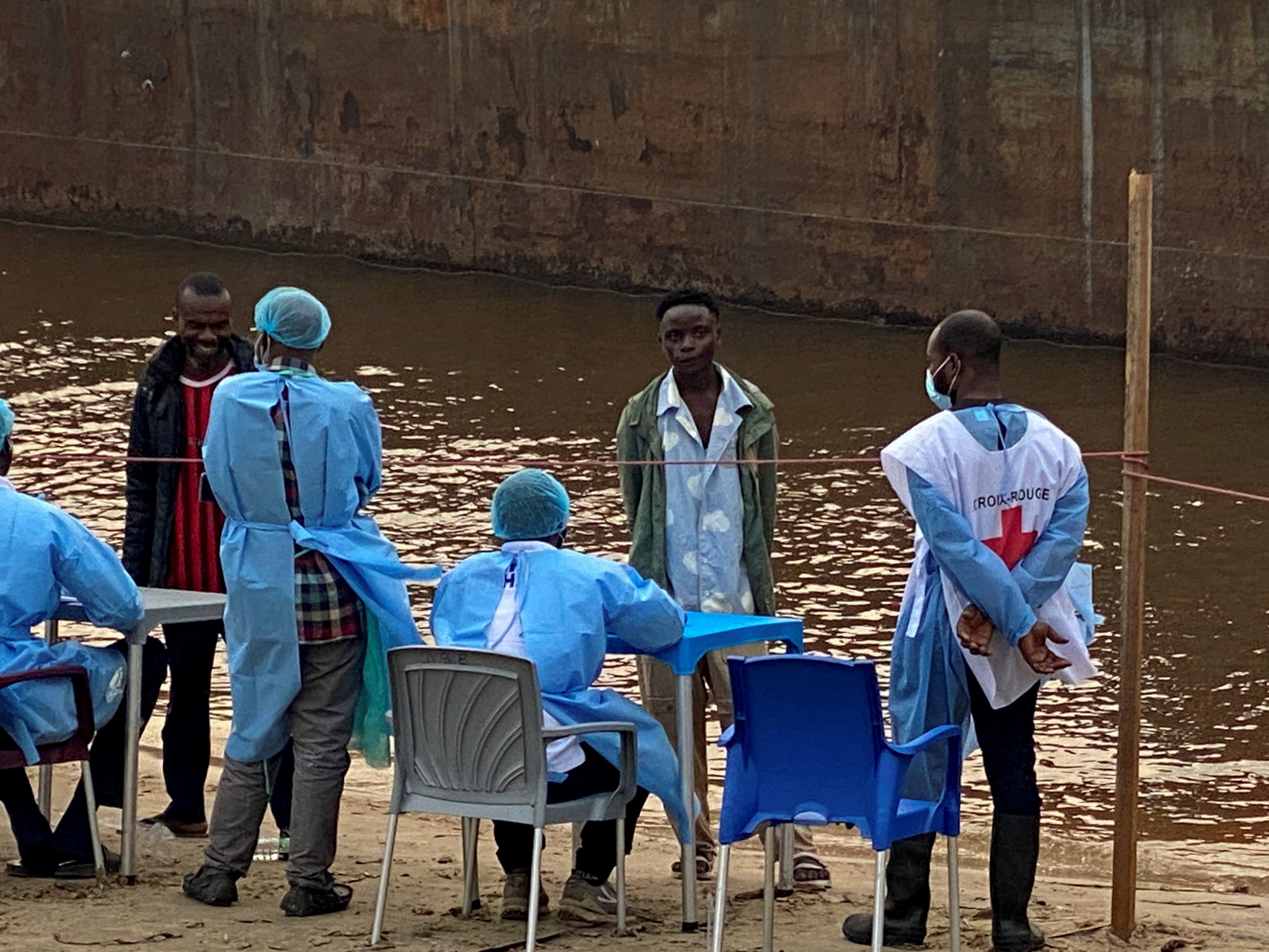 Passengers from an intercepted boat wait to be tested in Kinshasa, Democratic Republic of the Congo