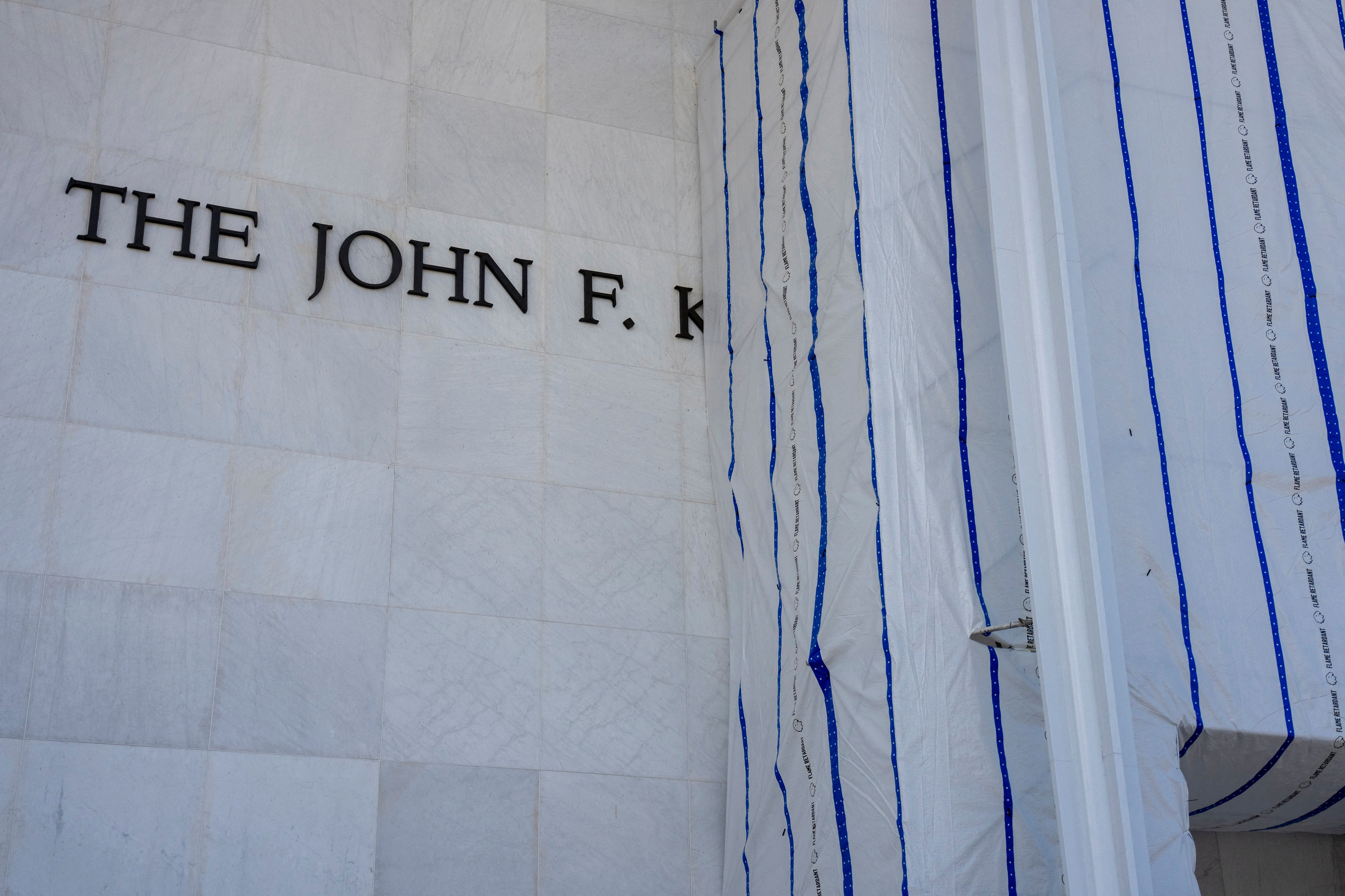 A tarp covers the name of the John F Kennedy Center for the Performing Arts.