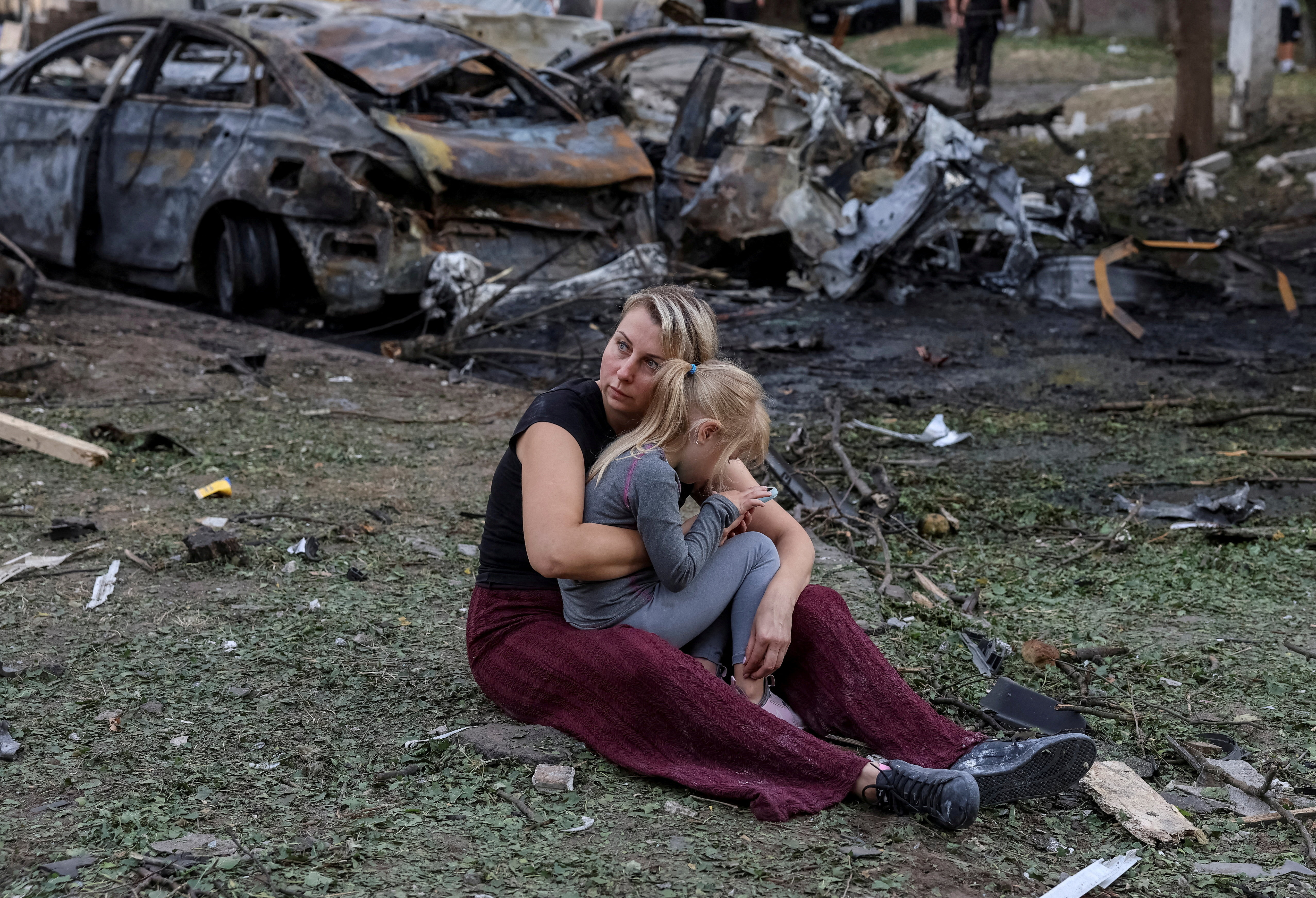 A resident Nataliia and her daughter Elia, 6, sit at a site of an apartment building damaged by a Russian missile strike, amid Russia's attack on Ukraine, in the town of Borispil, Ukraine September 1, 2026. REUTERS/Stringer TPX IMAGES OF THE DAY REFILE - UPDATING TO REMOVE "PICTURE TAKEN WITH A MOBILE PHONE.".