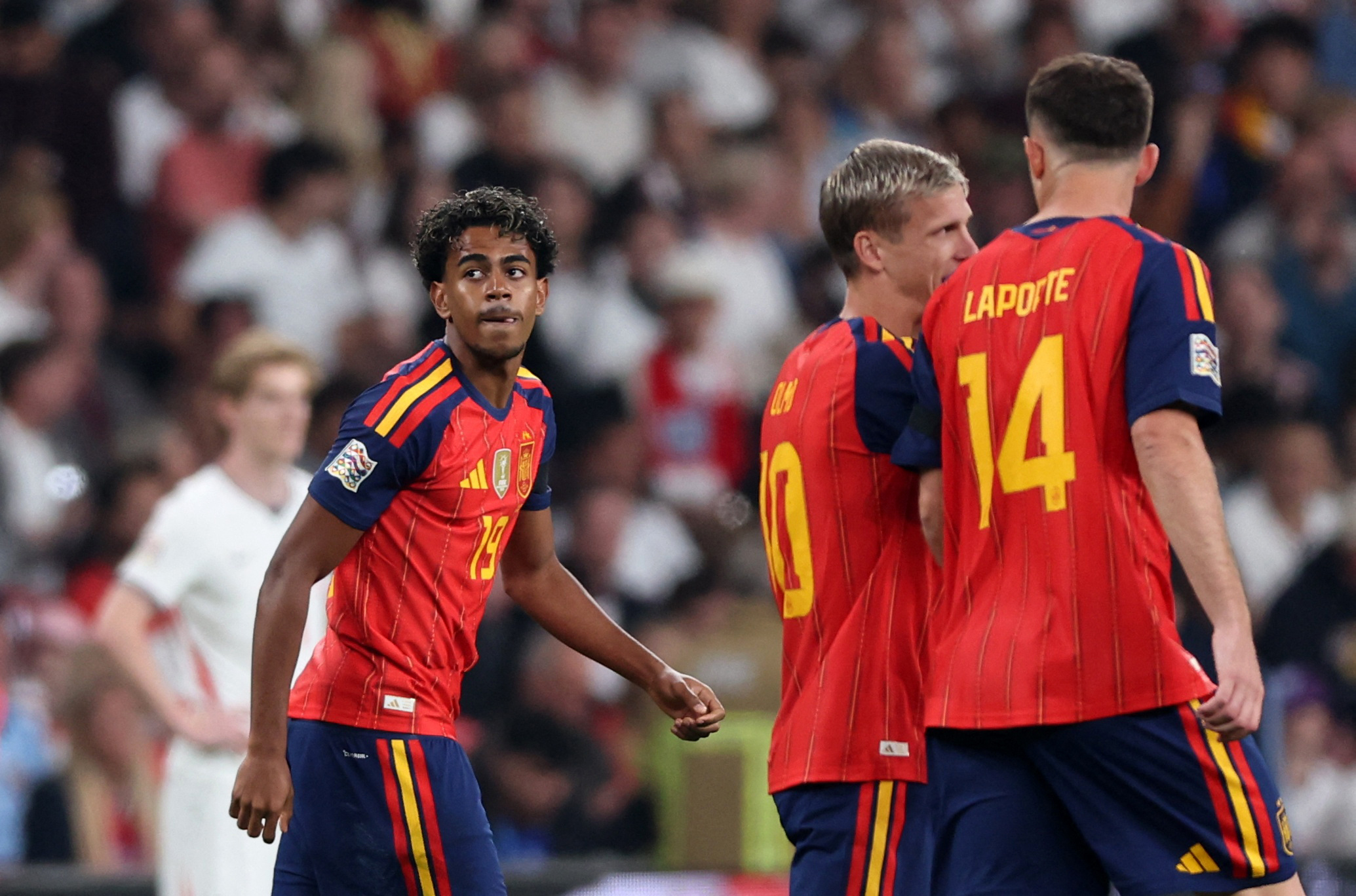 Spain's Lamine Yamal celebrates scoring their first goal with Dani Olmo and Aymeric Laporte