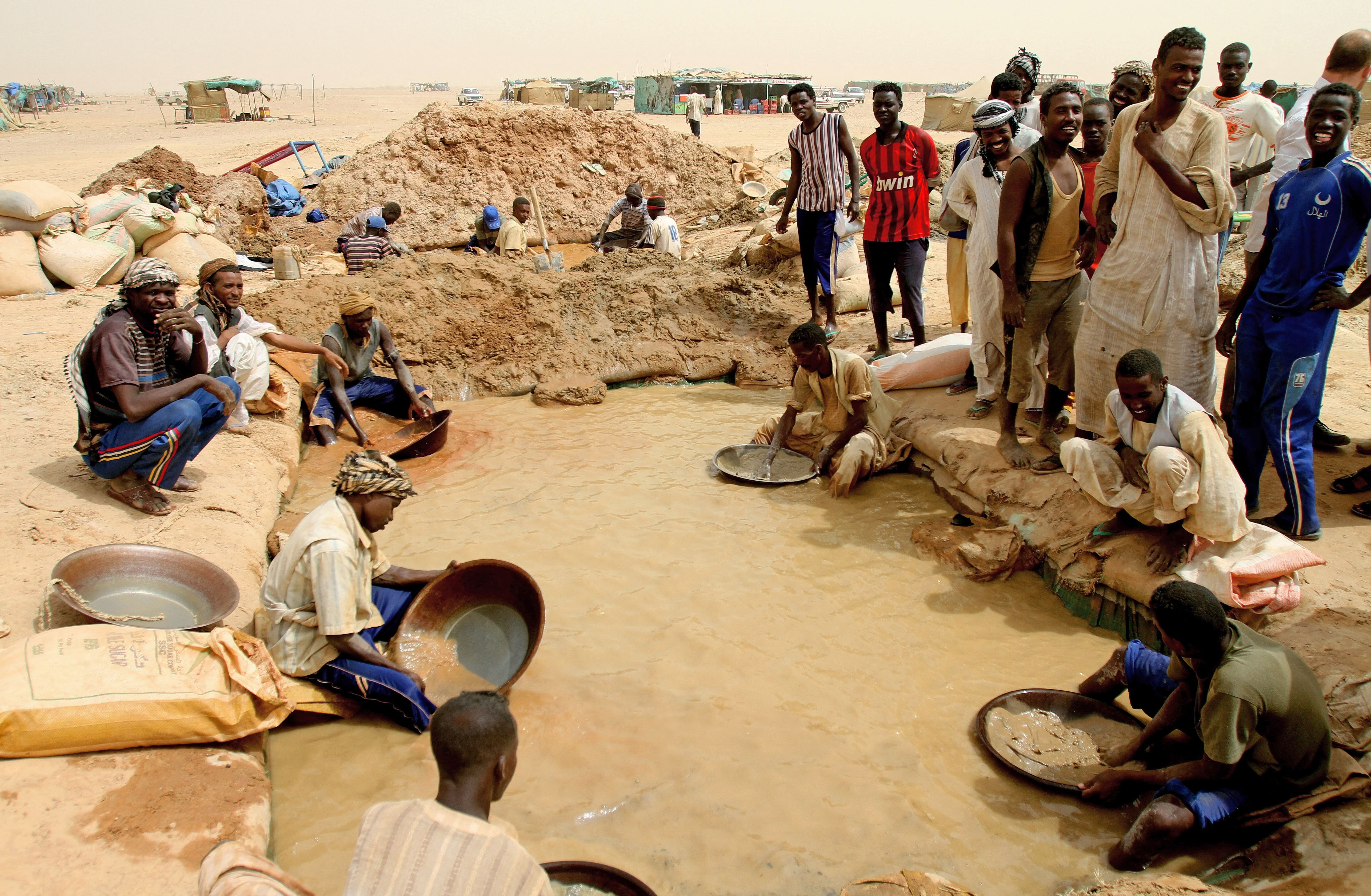 Sudanese men pan for gold