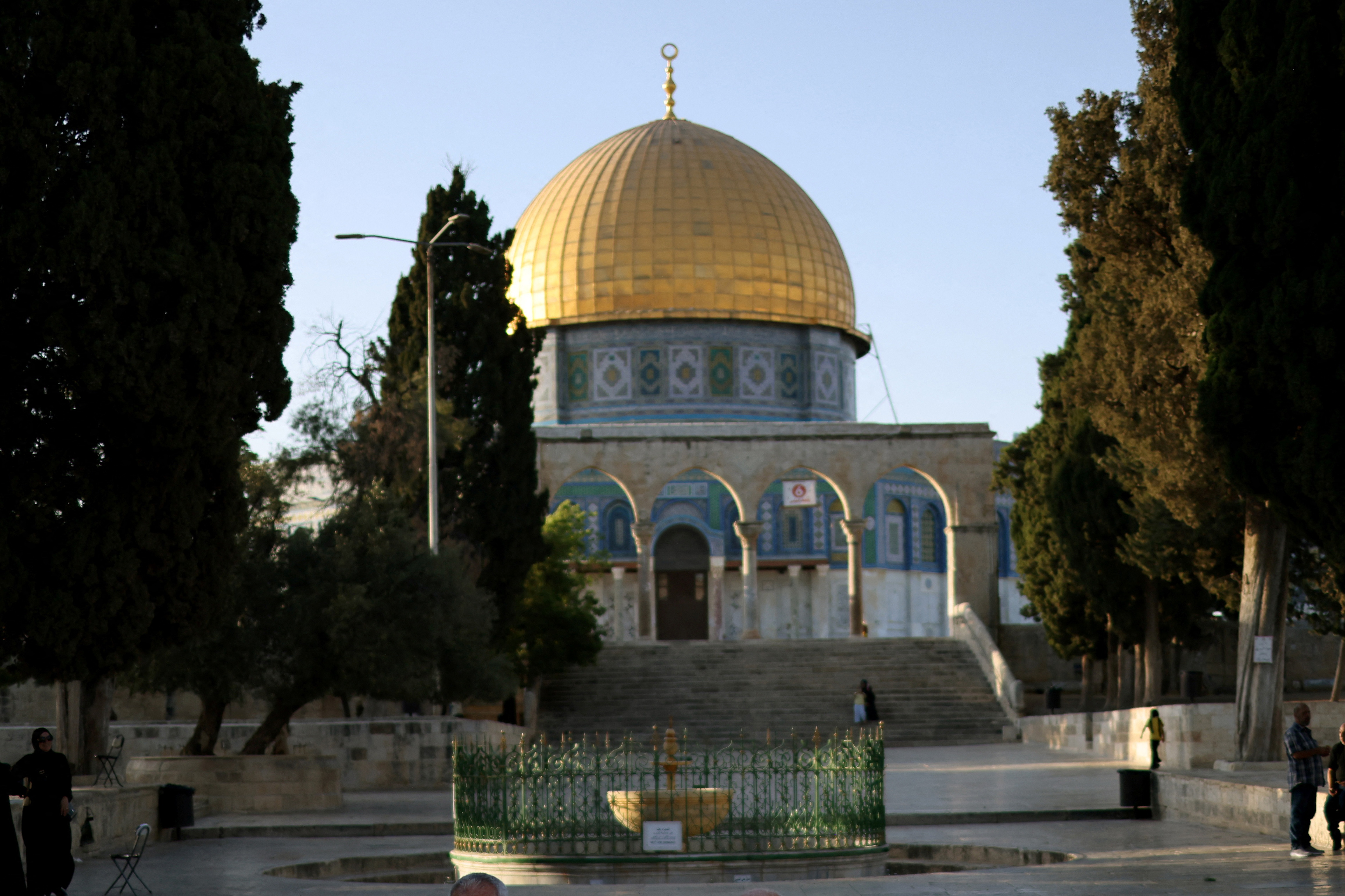 Palestinian Muslim men read the holy scriptures as they sit in the grounds of the Dome of the Rock mosque at the al-Aqsa Mosque complex, Islamís third holiest site in the old city of Jerusalem on August 4, 2026. The Jordan Foreign Ministry said in a statement on August 3, 2026 that Jordan will host a meeting on August 5, of the Arab ministerial committee, which will bring together Arab foreign ministers including the Secretary-General of the Arab League, and the foreign ministers of Indonesia, Pakistan, Turkey and Malaysia to discuss the situation in Jerusalem and its Islamic and Christian holy sites, aiming to coordinate a common position against what they describe as escalating and illegal Israeli actions targeting the city's identity and its religious sanctities. (Photo by AHMAD GHARABLI / AFP)