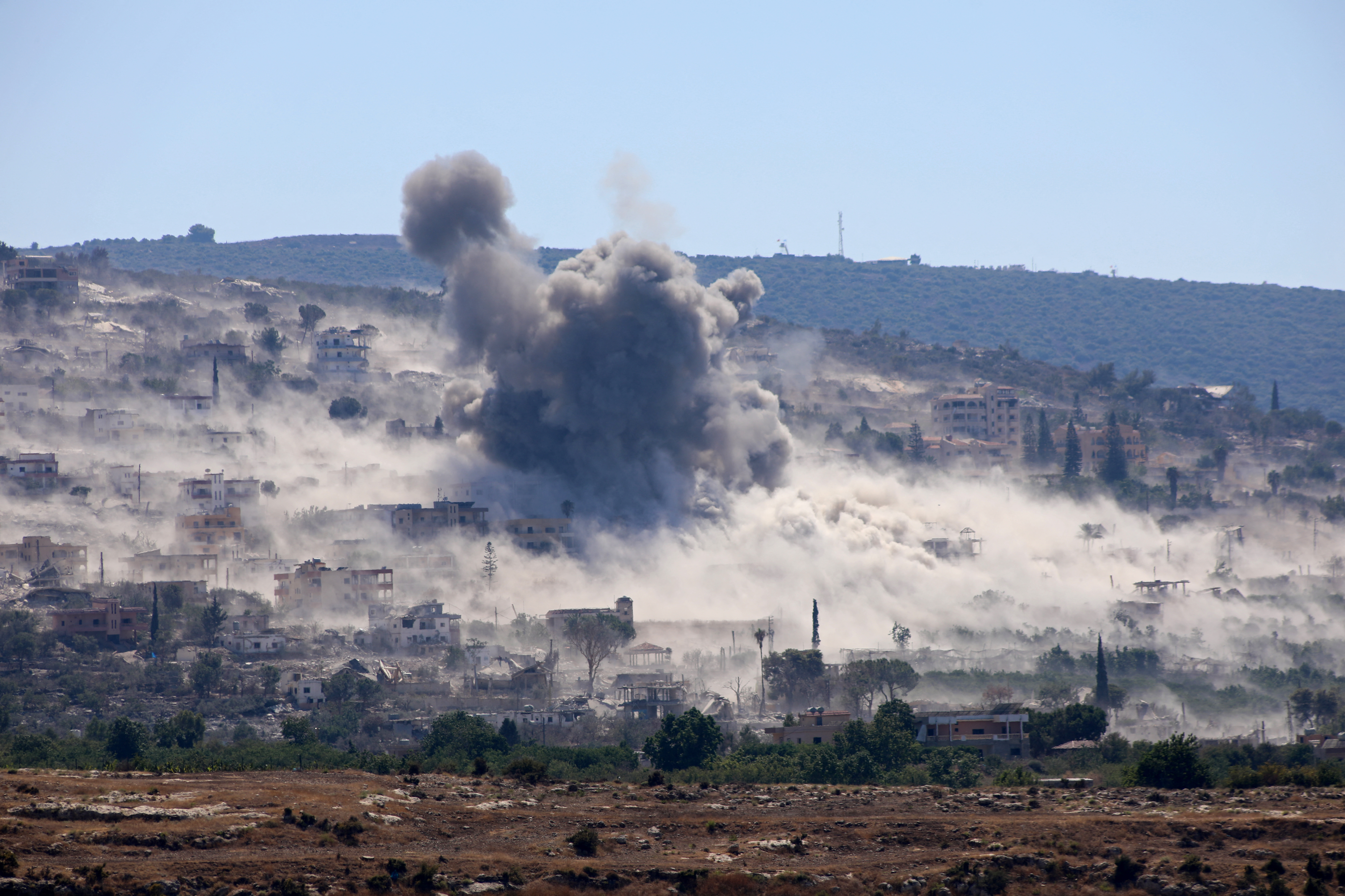 Smoke rises from the site of an attack on a village.