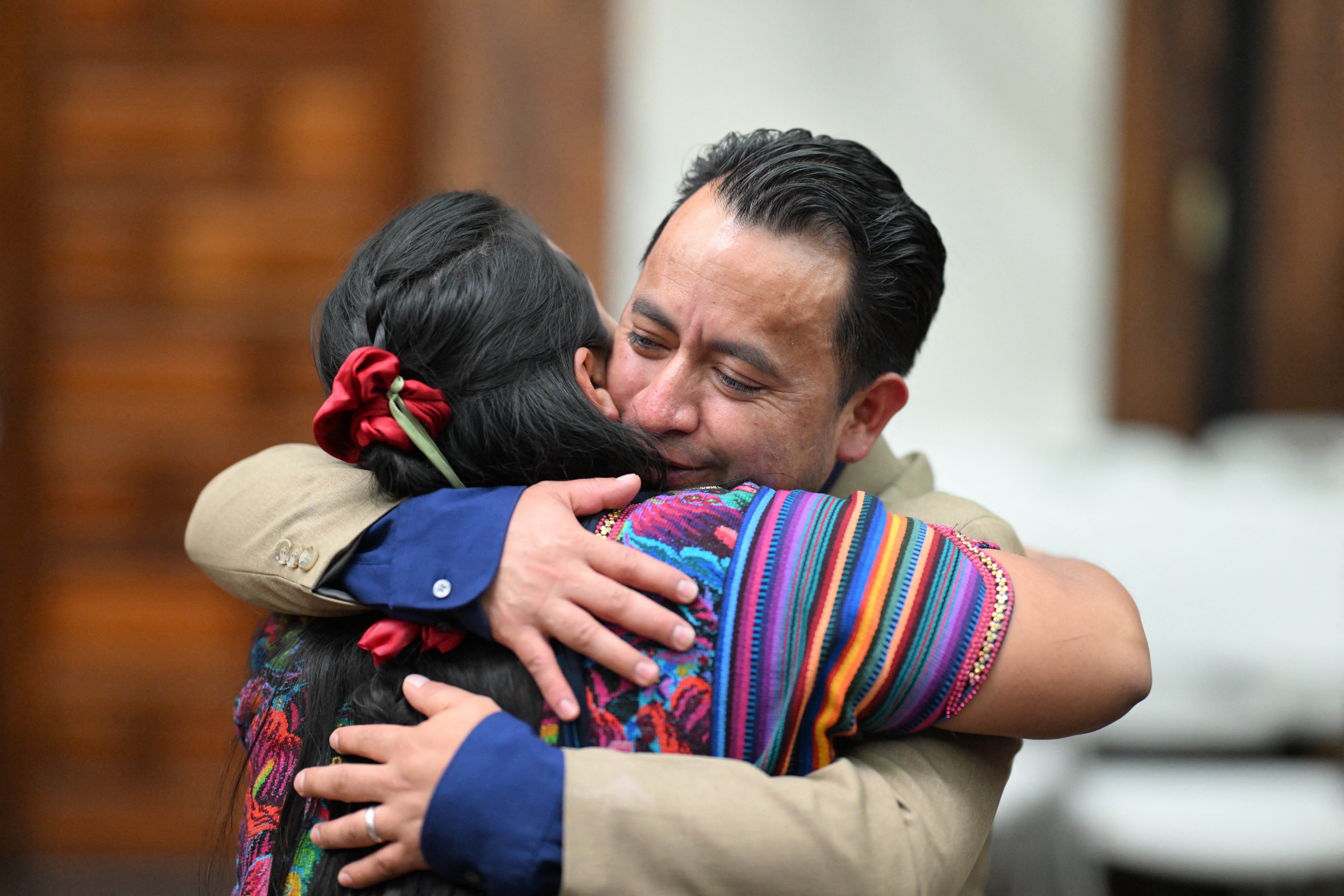Mayan leader and Deputy Minister of Energy and Mines Luis Pacheco hugs his wife, Lidia Tzunun.