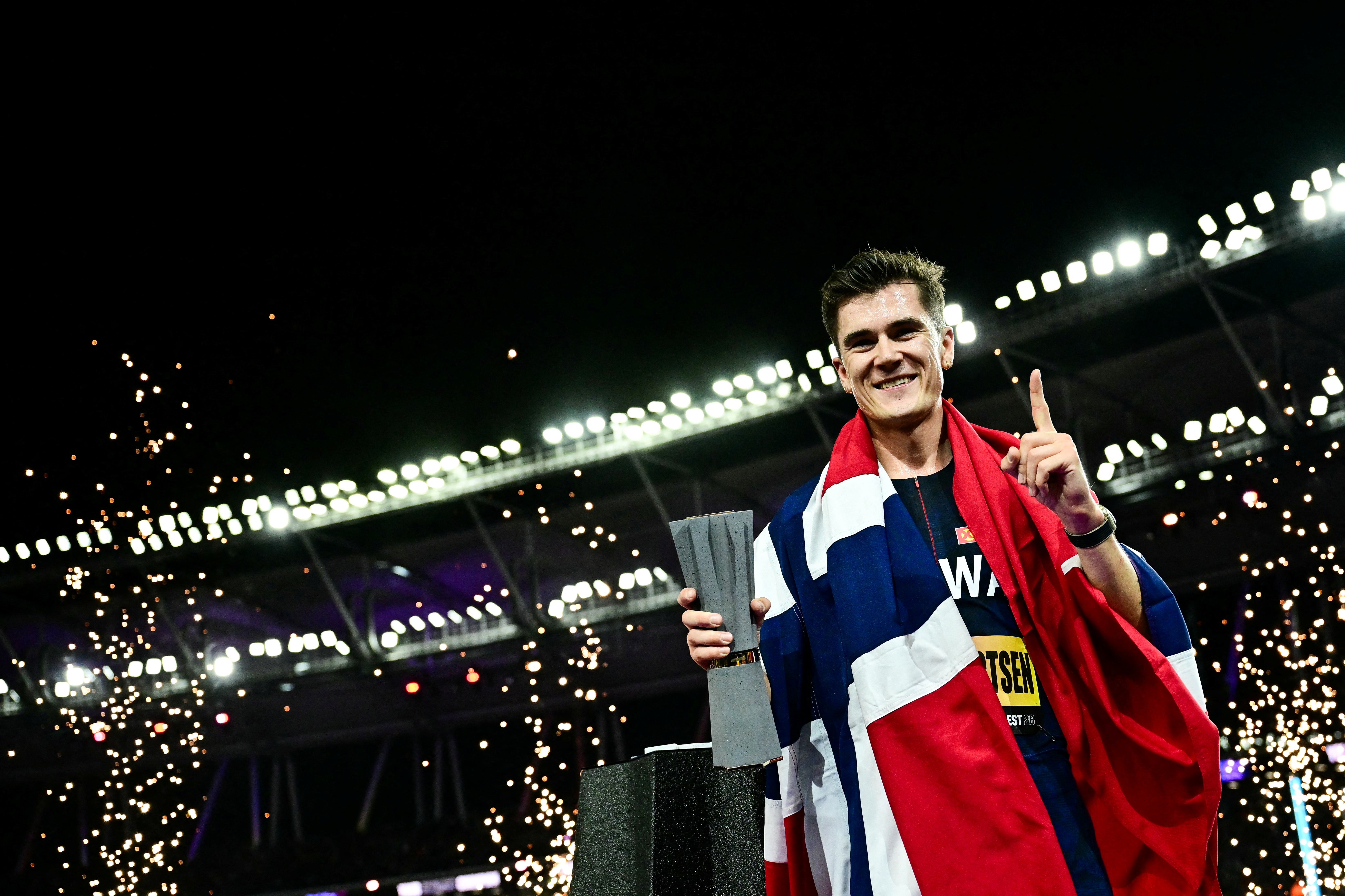 Winner Norway's Jakob Ingebrigtsen celebrates with his trophy following his victory in men's 5000m final during the World Athletics Ultimate Championship at the Gyula Zsivotzky National Athletics Centre, in Budapest on September 11, 2026. (Photo by Ben STANSALL / AFP)