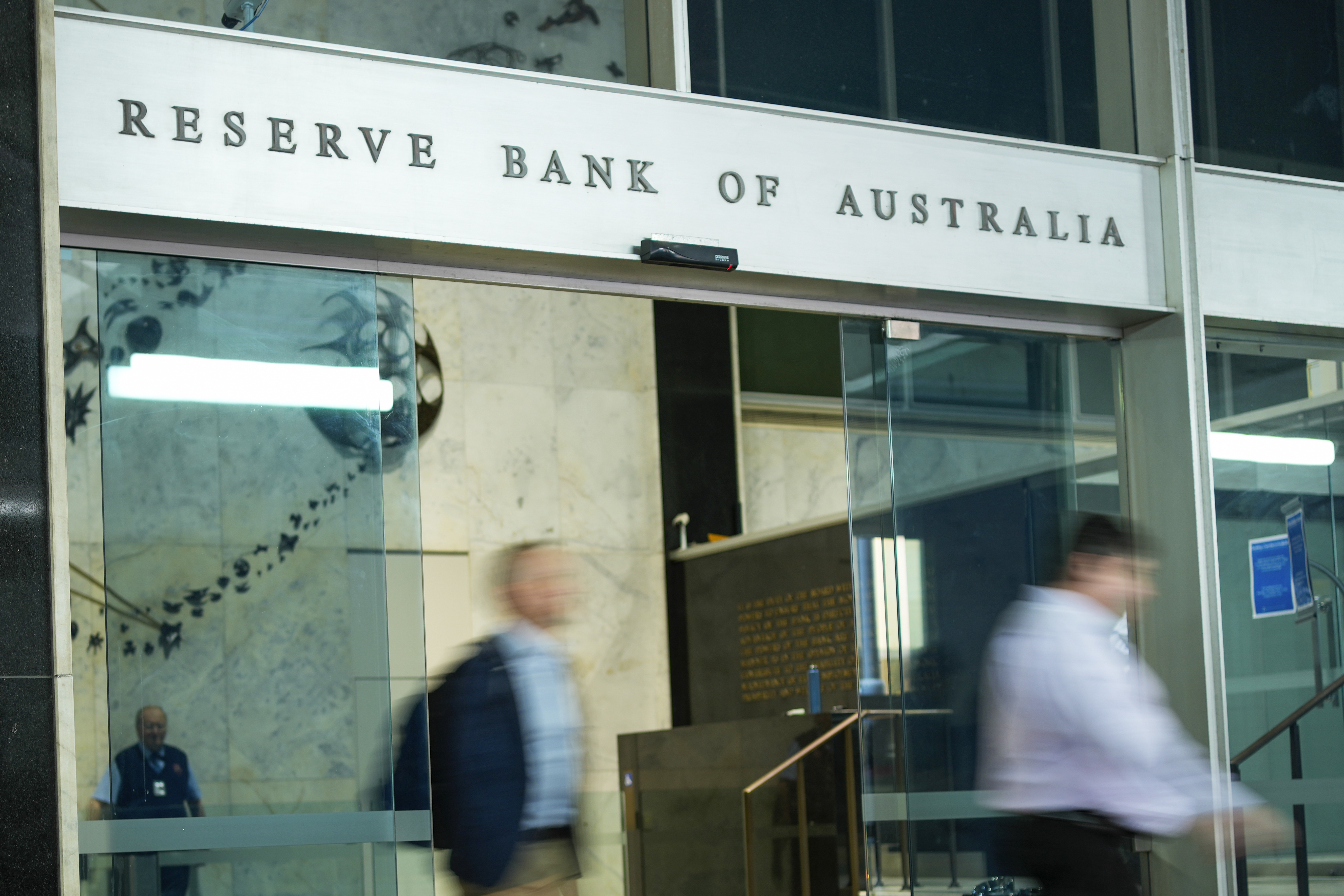 People walk out of the Reserve Bank of Australia