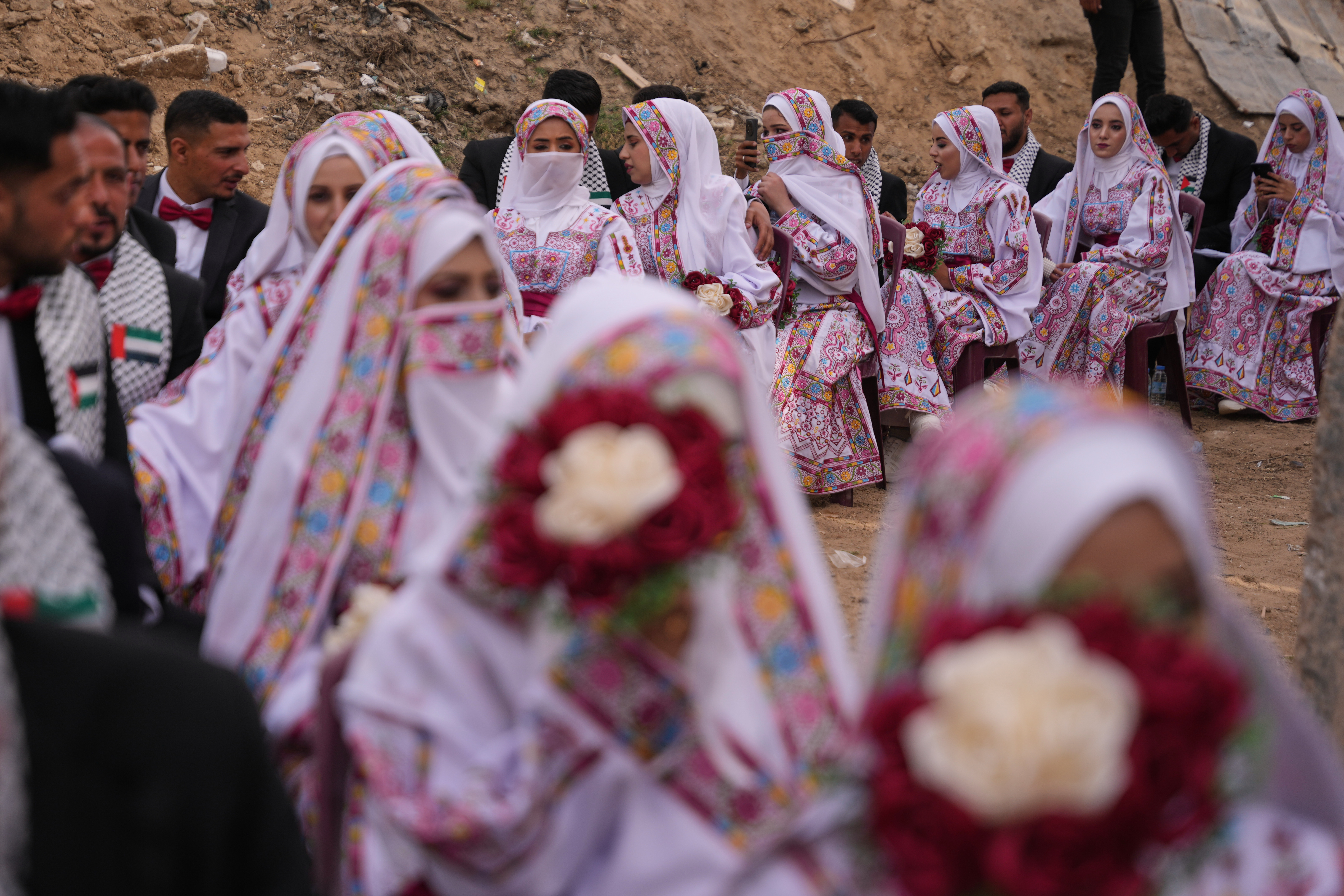 Palestinian couples participate in a mass wedding ceremony in Deir al-Balah, central Gaza Strip, on April 24, 2026 [Abdel Kareem Hana/AP]