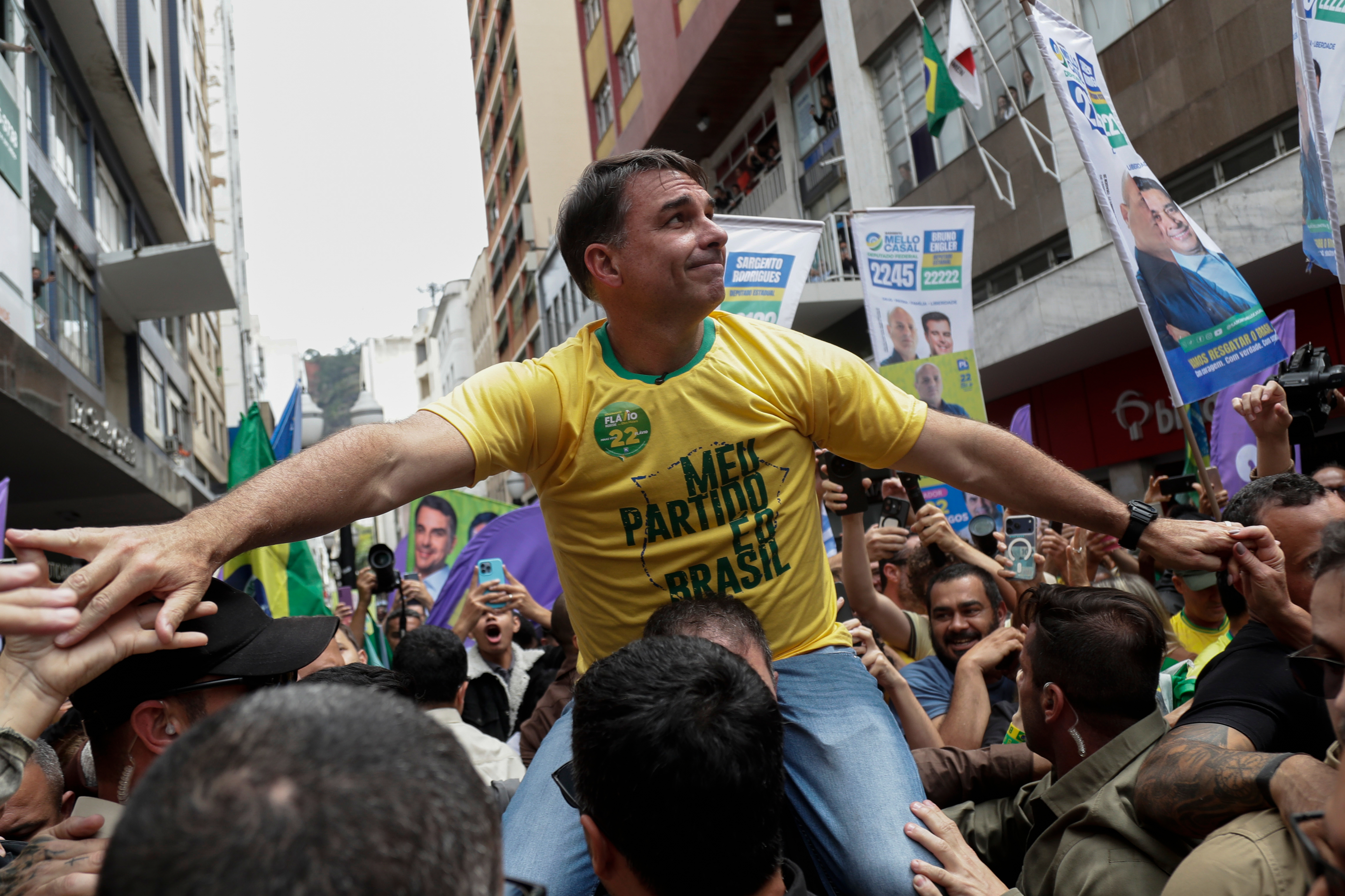 Presidential candidate Flavio Bolsonaro rides on a man's shoulders during his campaign rally at the site where his father, former President Jair Bolsonaro, was injured by a stabbing attack in 2018, in Juiz de Fora, Minas Gerais state, Brazil, Wednesday, Sept. 9, 2026. (AP Photo/Bruna Prado)