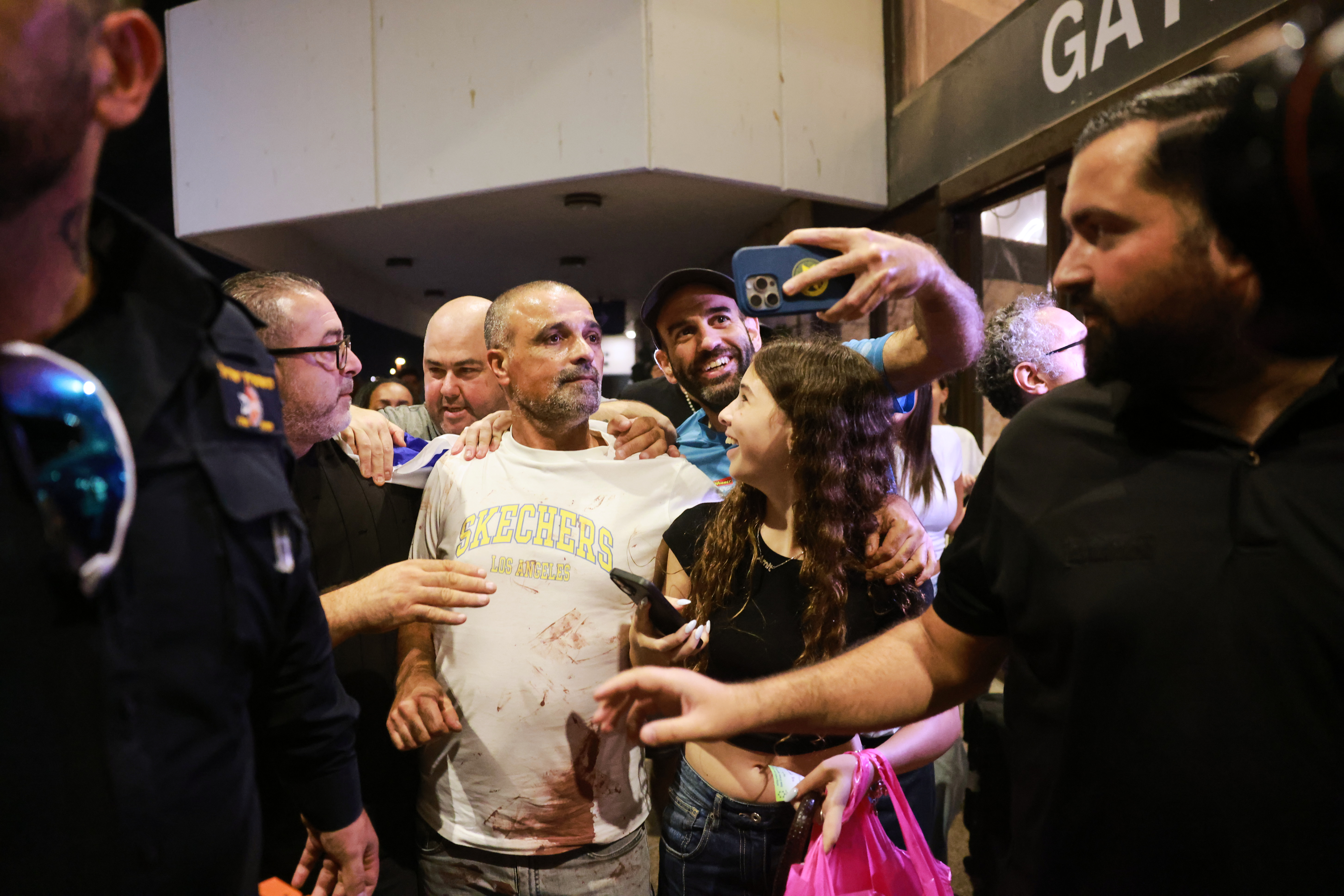Israeli passenger Yaniv Hayoun, with blood stains on his shirt, who was aboard a Flydubai aircraft that made an emergency landing in Saudi Arabia, is welcomed at the arrivals gate at Ben Gurion International Airport near Tel Aviv, Israel, Wednesday, September 30, 2026 [Tomer Appelbaum/AP]