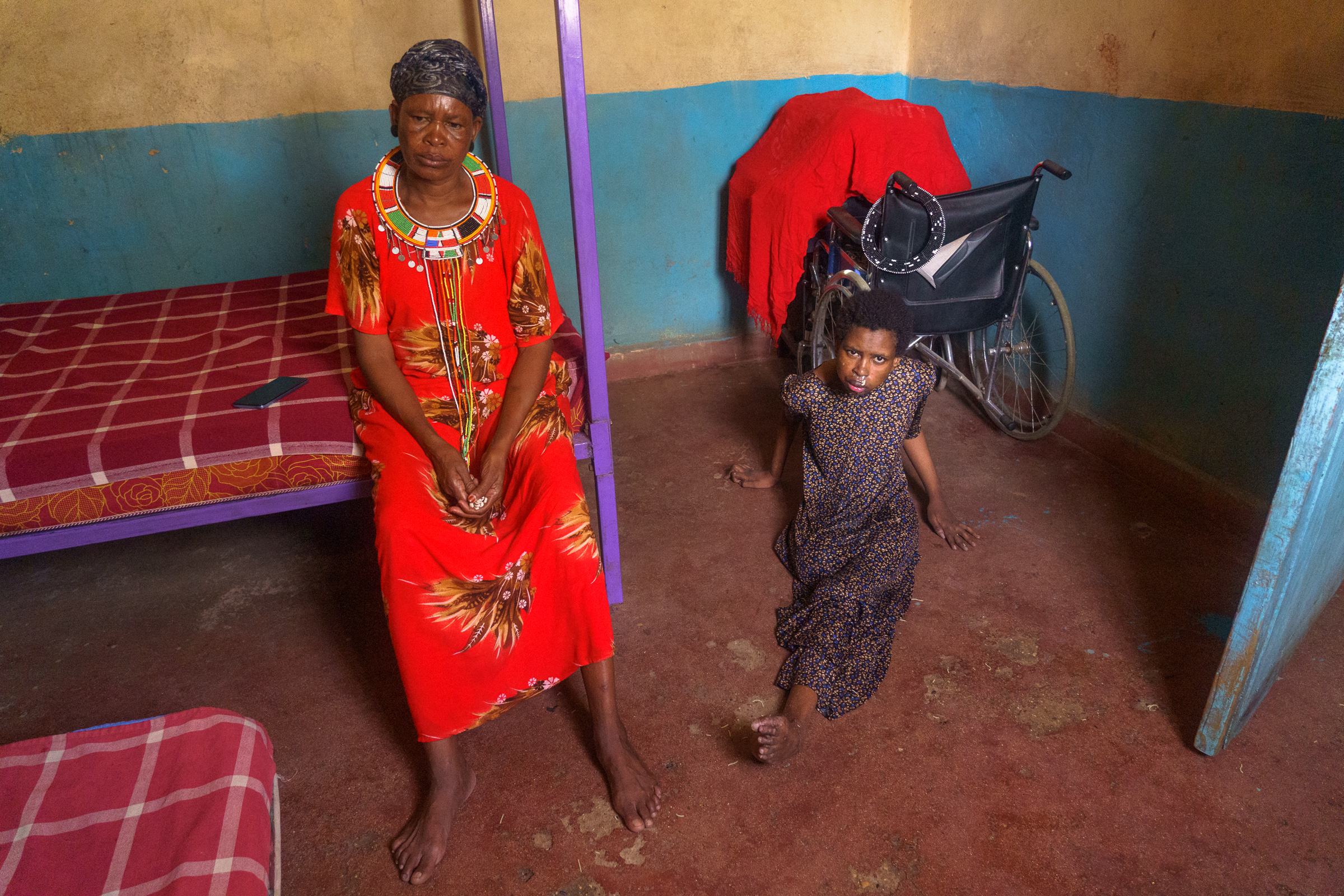 Memusi Lochede at her home in Archer's Post with her daughter Chaula, who lost her leg after being hit by a speeding BATUK vehicle in 2019 [Jaclynn Ashly/Al Jazeera]