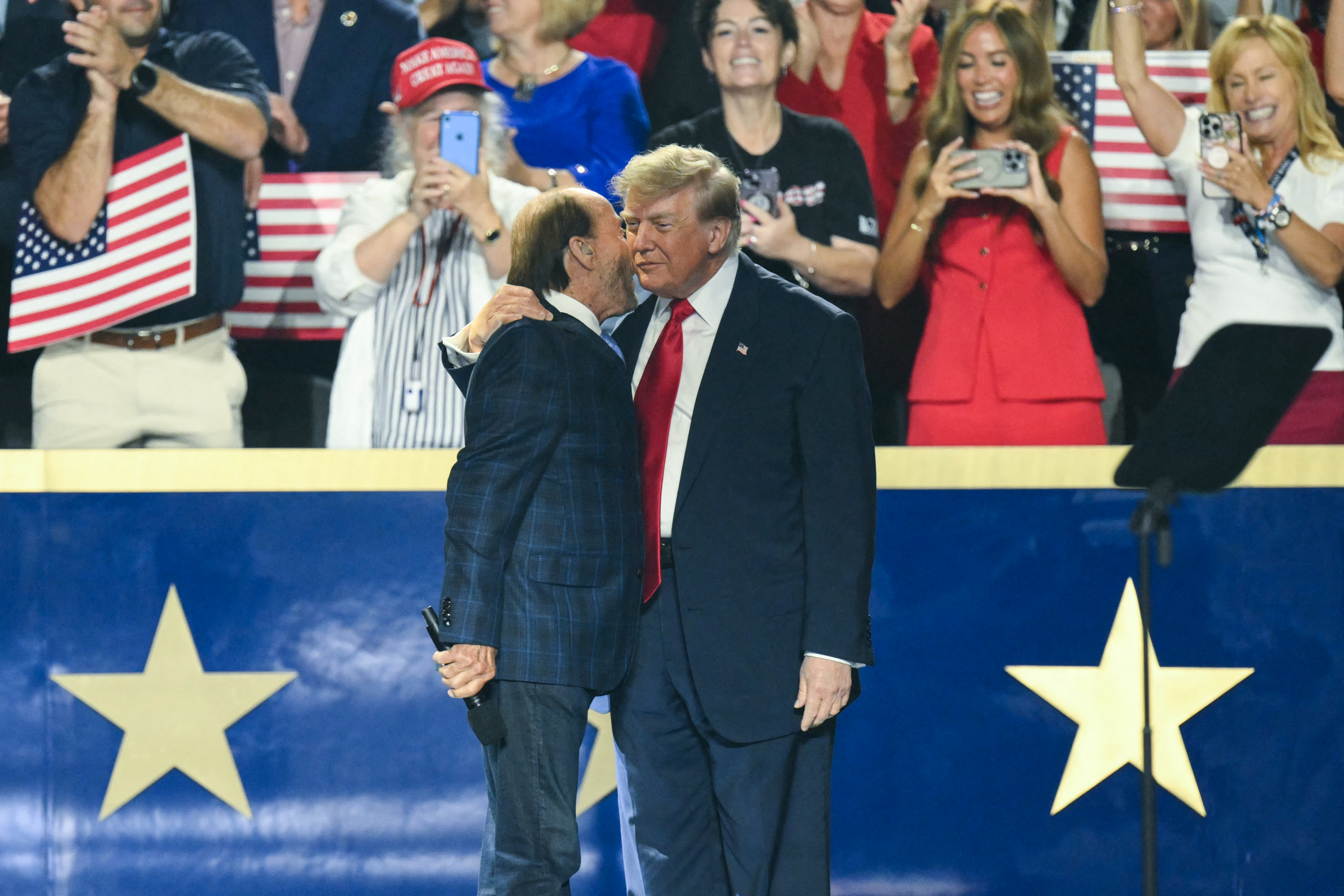 US President Donald Trump greets US singer Lee Greenwood before speaking during the second day of the Republican National Committee midterm convention at the American Airlines Center in Dallas, Texas on September 10, 2026.