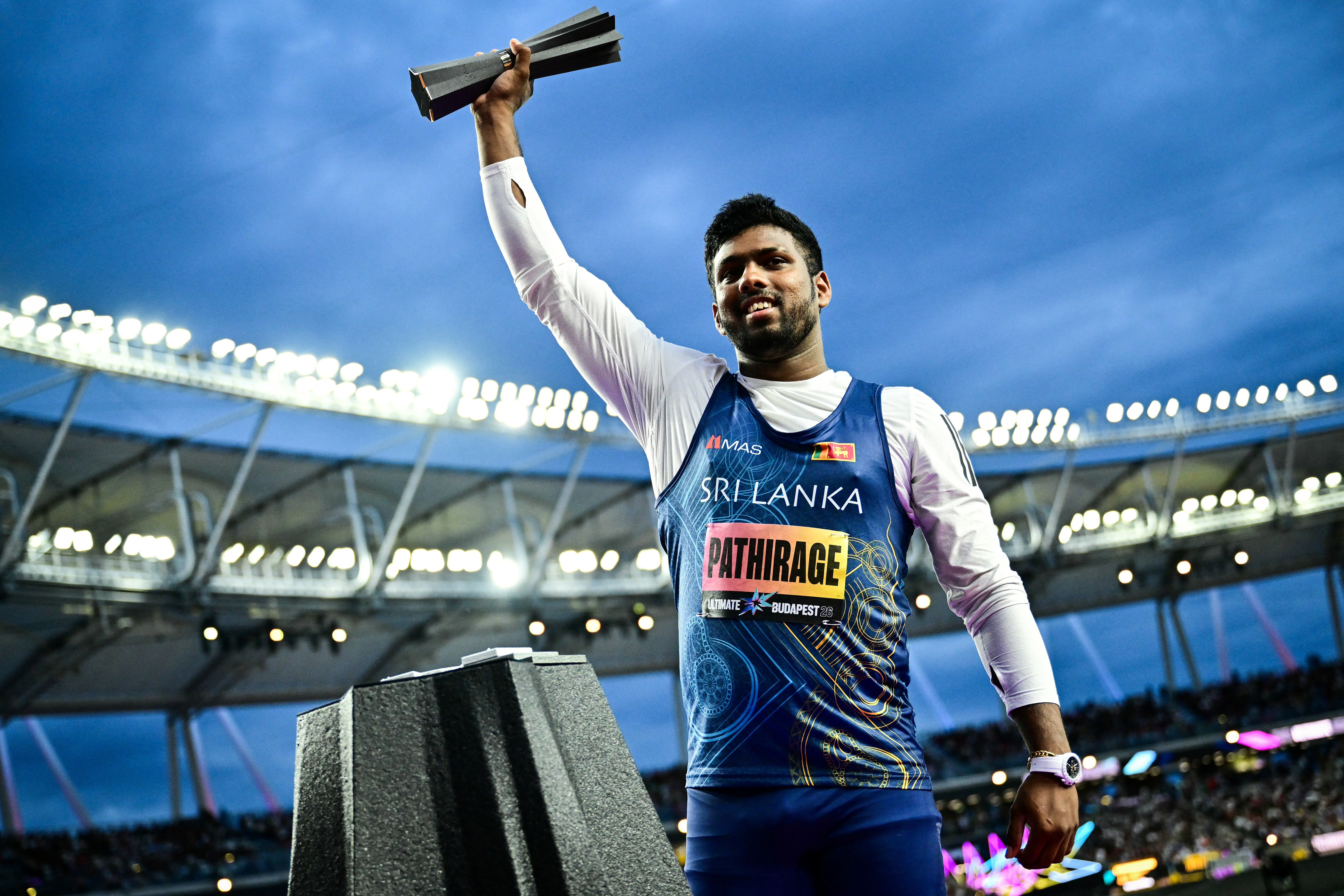 Sri Lanka's Rumesh Tharanga Pathirage celebrates with the trophy after his victory in men's javelin throw final during the World Athletics Ultimate Championship at the Gyula Zsivotzky National Athletics Centre, in Budapest on September 13, 2026. (Photo by Ben STANSALL / AFP)
