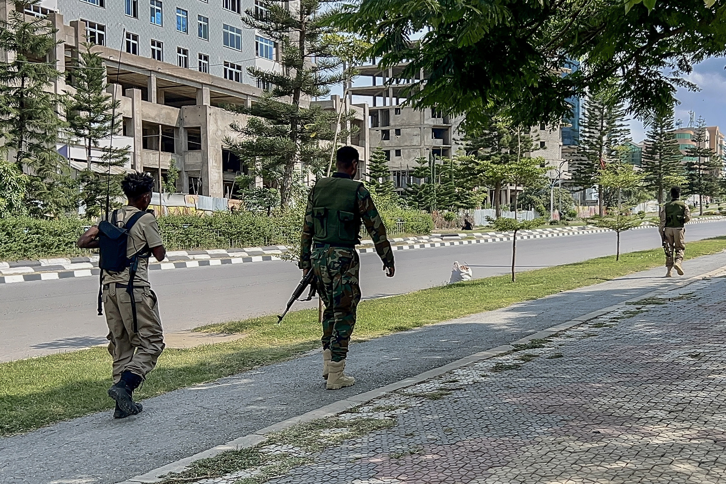 TOPSHOT - Members of the Tigray People's Liberation Front (TPLF) walk along a main road in Mekelle on September 23, 2026, as tensions intensify in northern Ethiopia after Tigrayan rebels seized control of airports in the region.