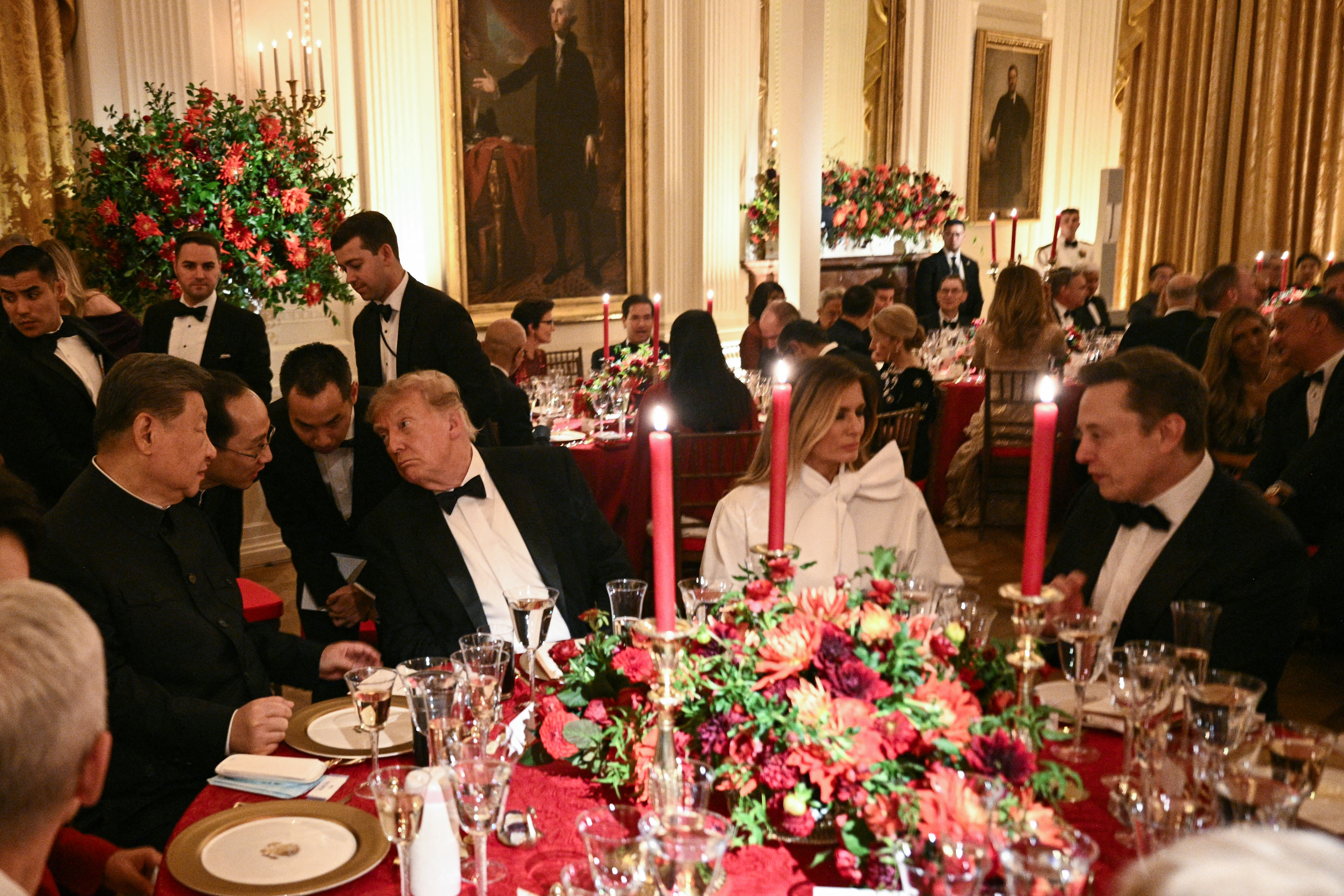 TOPSHOT - China's President Xi Jinping (L) and US President Donald Trump speak through interpreters as First Lady Melania Trump listens to Tesla CEO Elon Musk during a State Dinner in the East Room of the White House in Washington, DC, on September 24, 2026.
