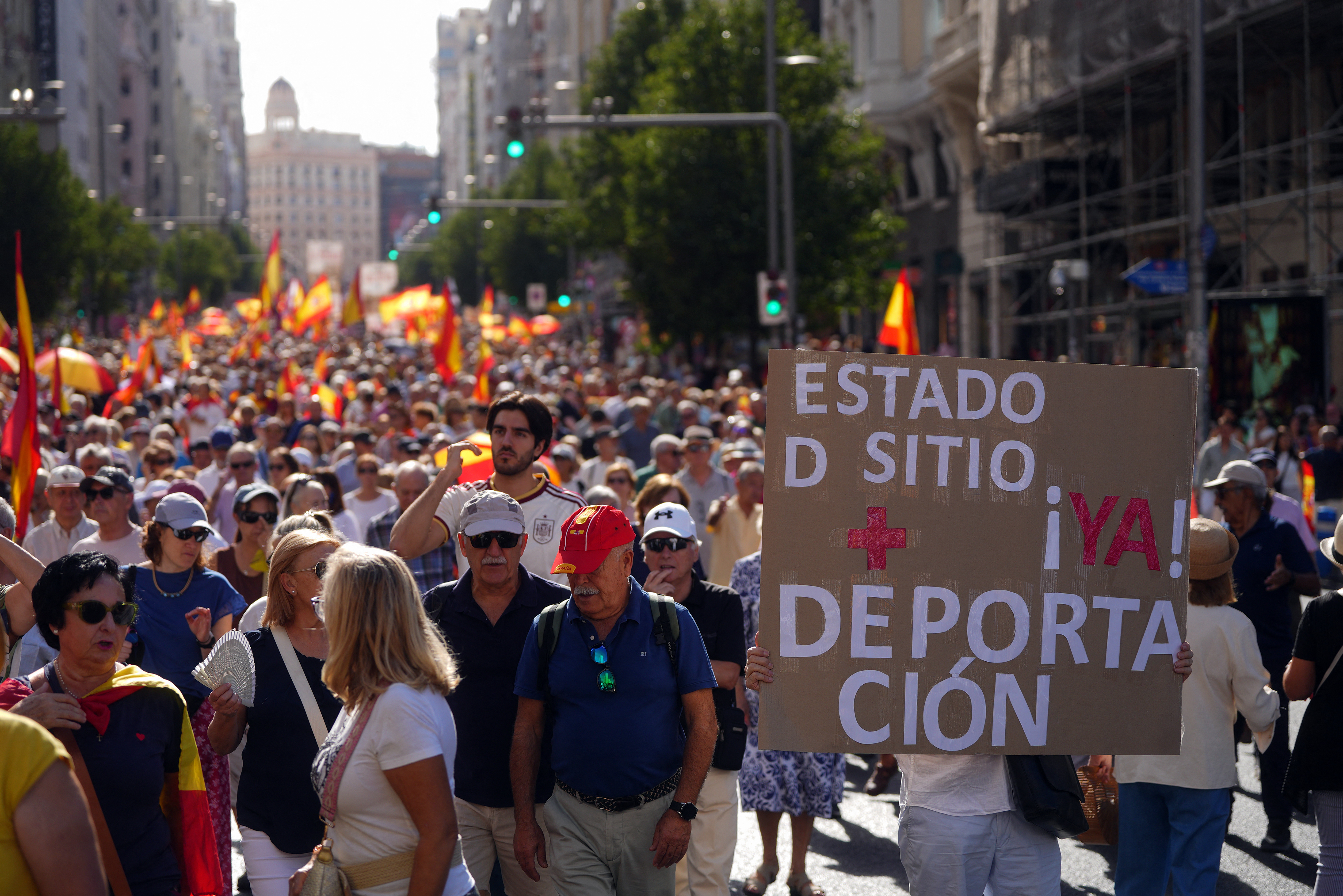 Demonstrators hold a banner reading 'state of siege and deportation now' during a protest against the Spanish government's handling of a migrant influx into Ceuta