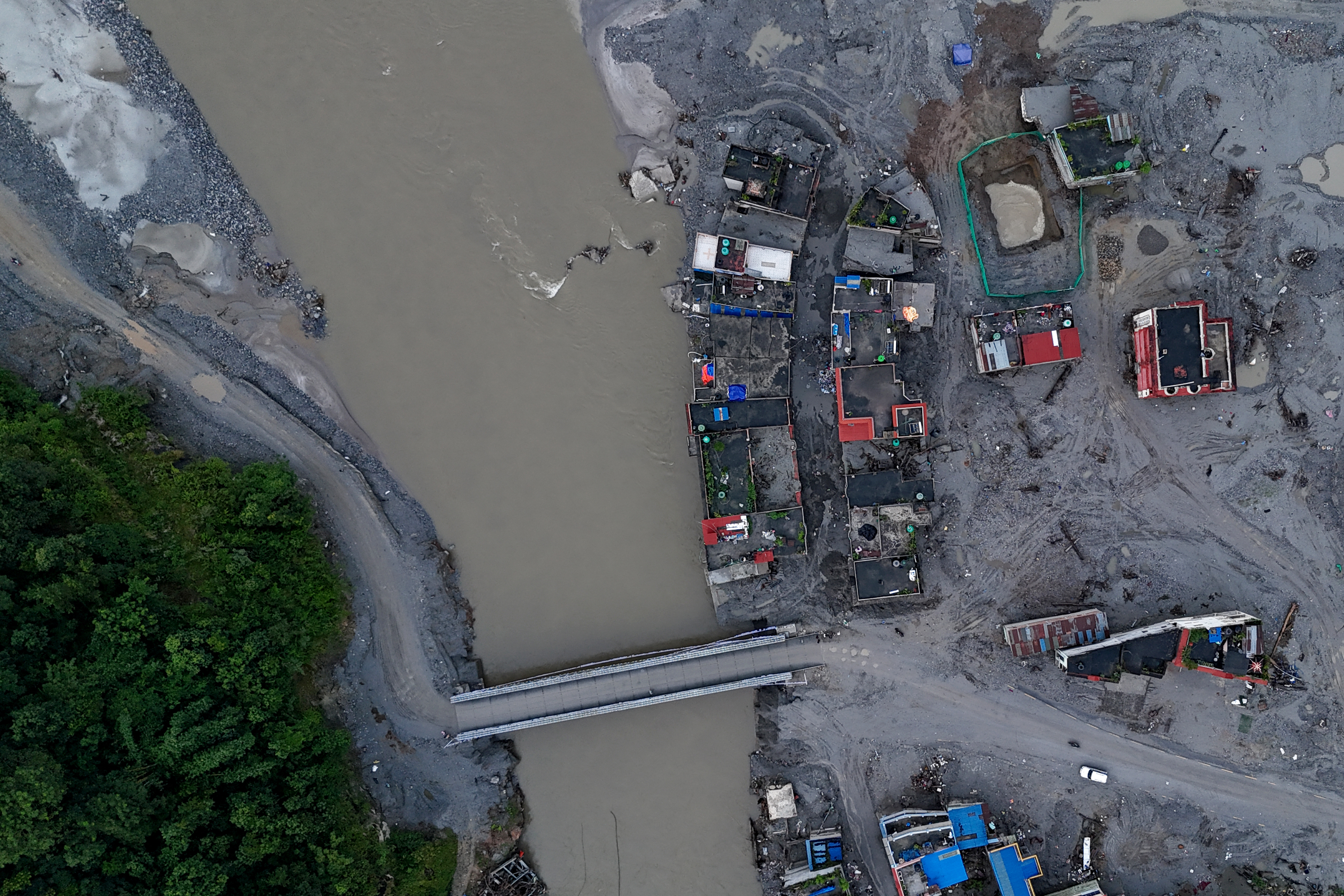 An aerial view shows sludge-ridden houses along the Tadi riverline at Devighat in Nepal's Nuwakot district on September 26, 2026, in the aftermath of the August 26 flash flood.