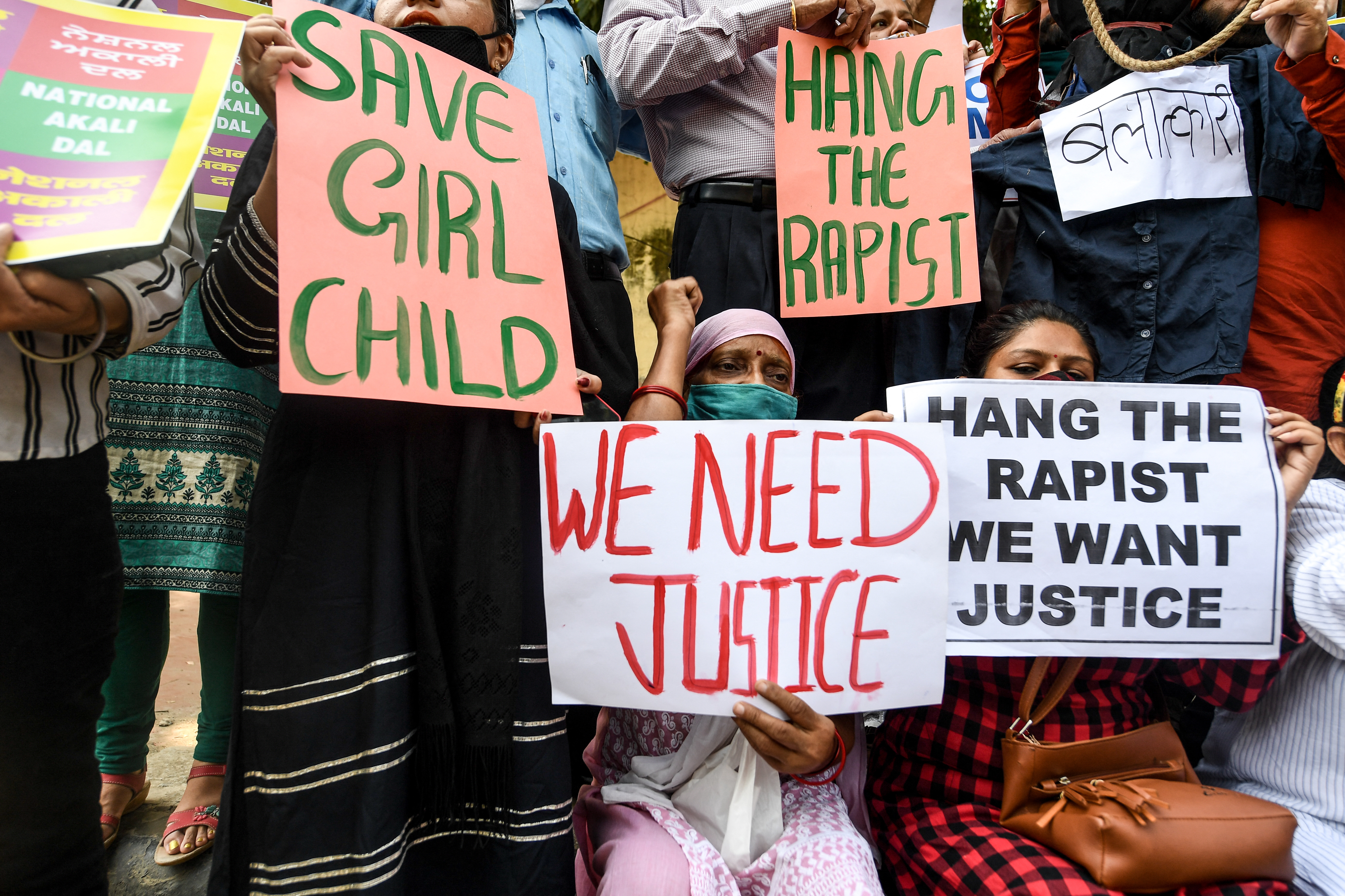 (FILES) National Akali Dal party activists hold placards to protest against the alleged gang-rape and murder of a 19-year-old woman in Uttar Pradesh state, demanding justice against the accused during a demonstration in New Delhi on October 4, 2020.