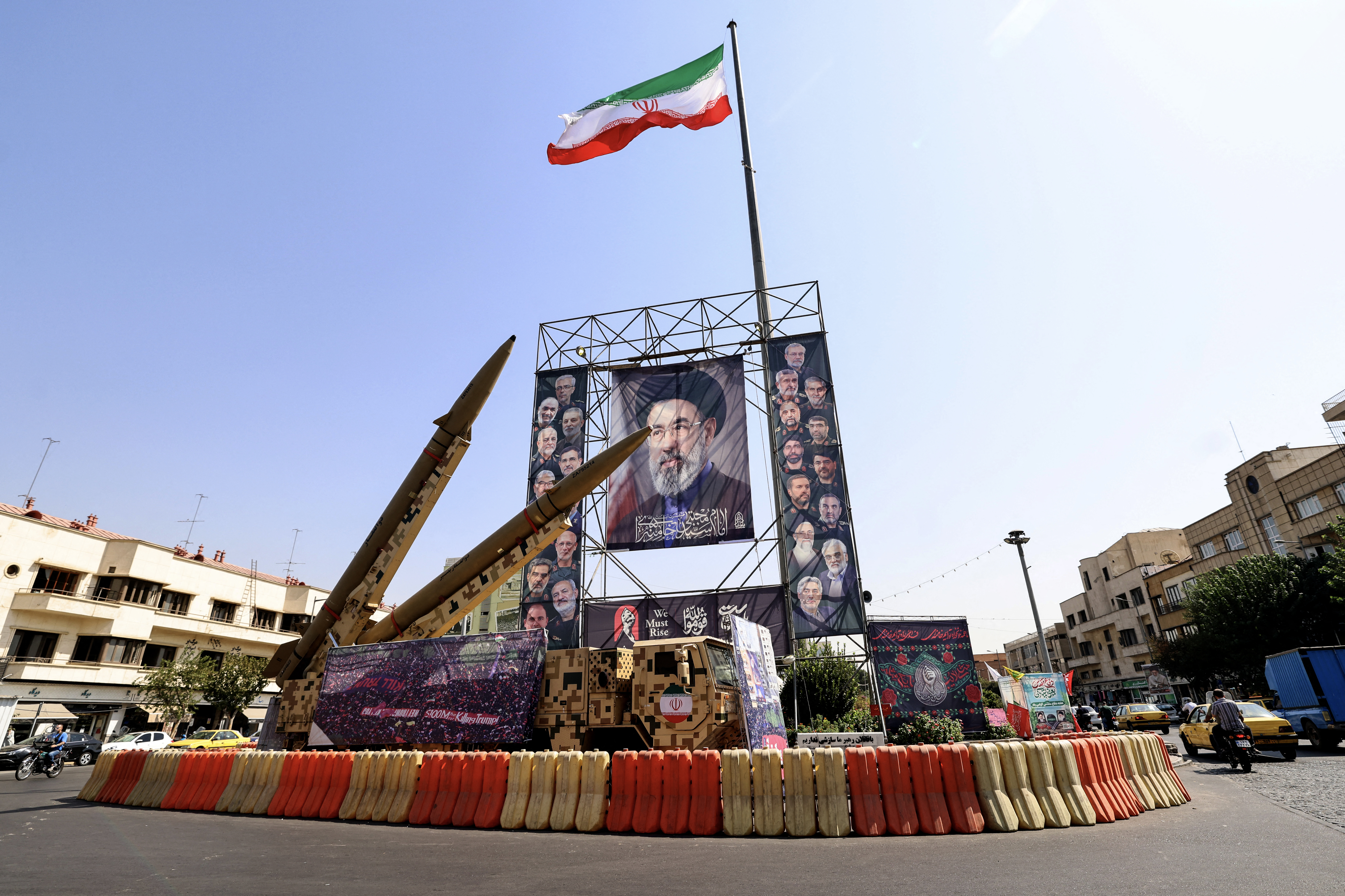 Iranian-made Zolfaghar missiles are seen on display beside a large portrait of Iran's supreme leader Mojtaba Khamenei at Baharestan Square in Tehran on September 28, 2026
