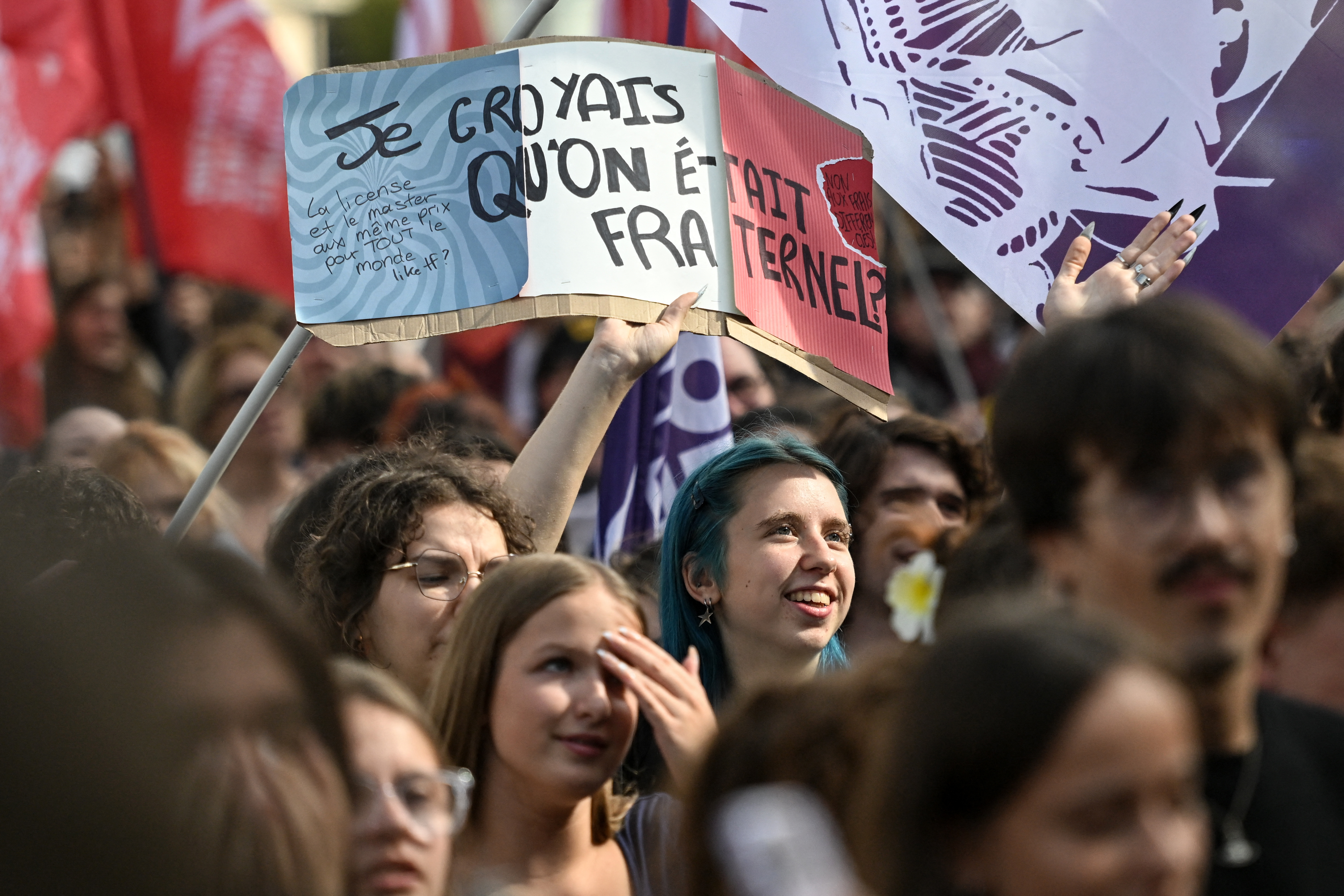 A student raises a placard reading "I thought we were fraternal" during a rally on a day of nationwide public sector strikes and demonstrations, in Rennes, western France, on September 29, 2026.