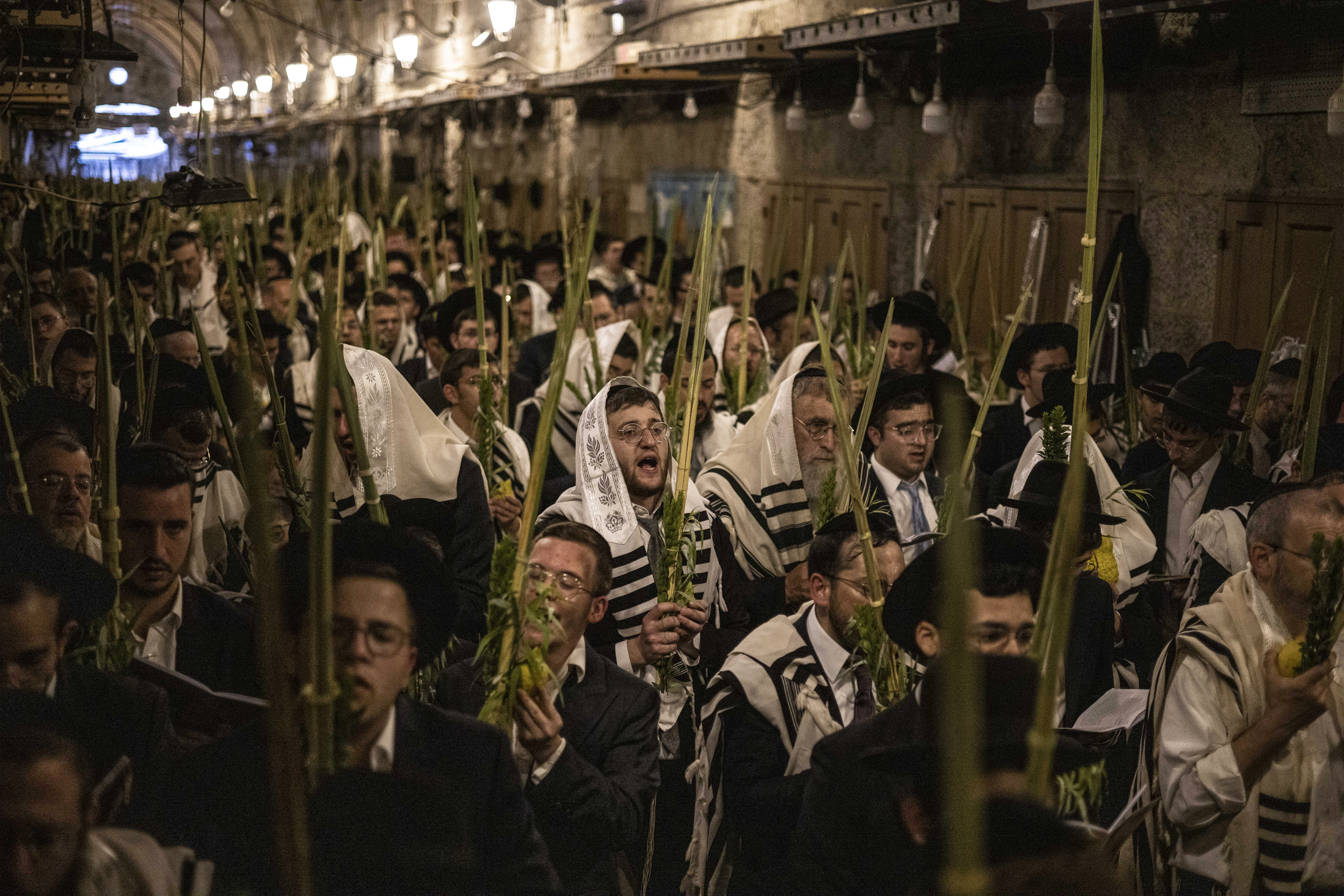 Israeli settlers pray near the Bab al-Qattanin (Cotton Merchants Gate) of the Al-Aqsa Mosque compound