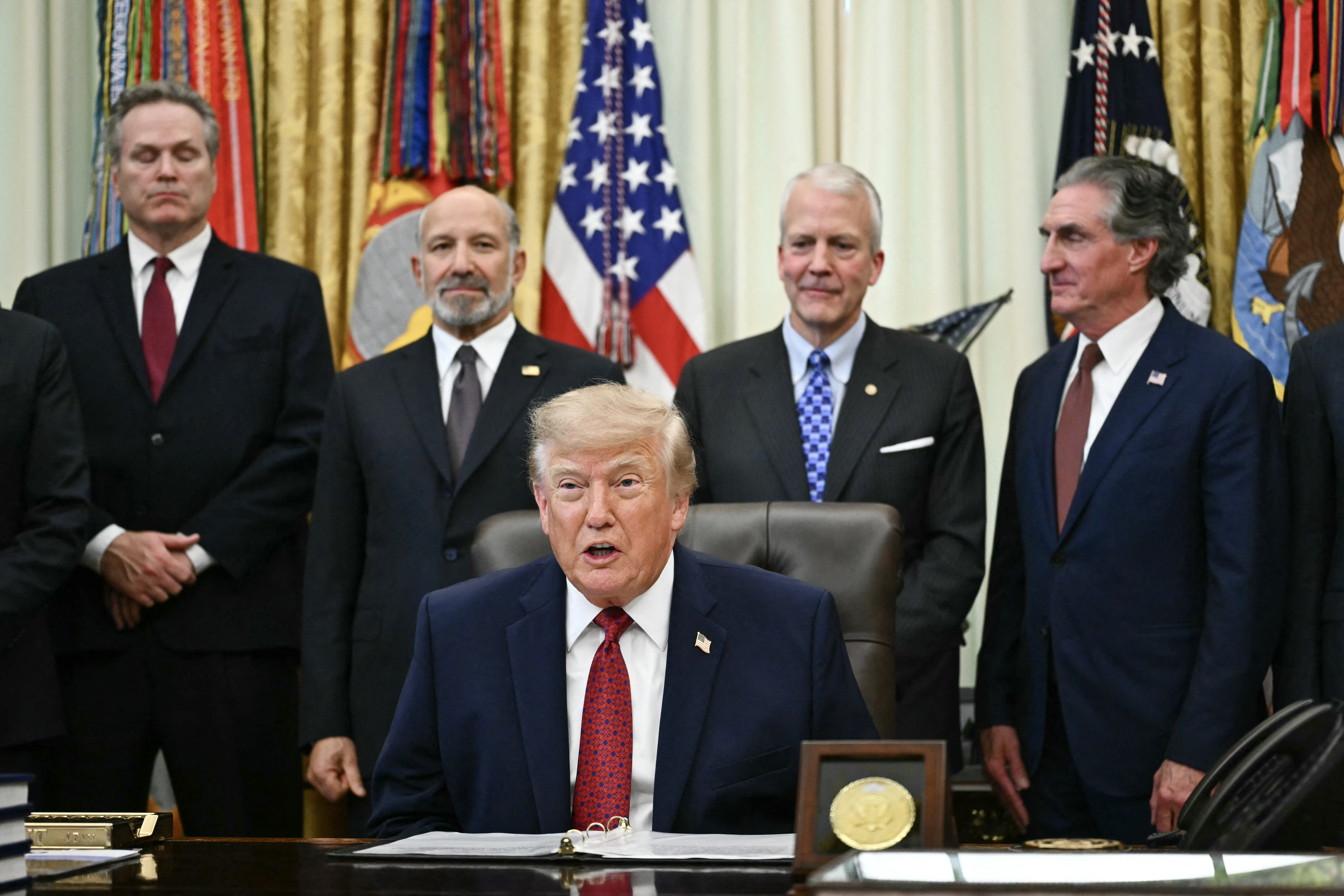 US President Donald Trump makes an announcement with US Secretary of Commerce Howard Lutnick (2L) in the Oval Office of the White House in Washington, DC, on September 30, 2026. Also picture, US Senator Dan Sullivan (2R), Republican from Alaska, and US Secretary of the Interior Doug Burgum (R).