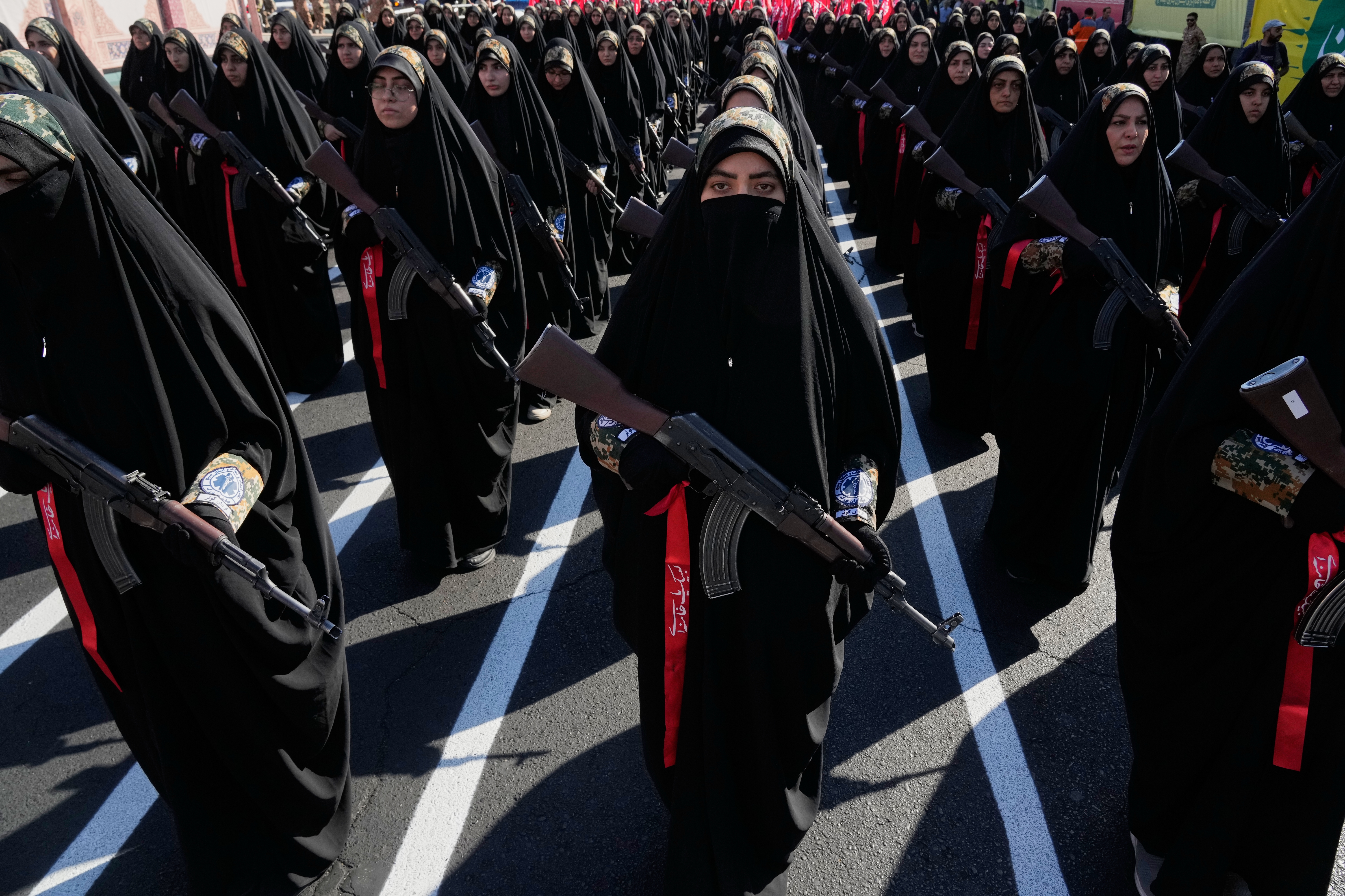 Women affiliated with Iran's Revolutionary Guard carry rifles as they stand during the state-organized "Janfada," or "Sacrifice for Iran," military-style parade in Tehran, Iran, Friday, Sept. 18, 2026. (AP Photo/Vahid Salemi)