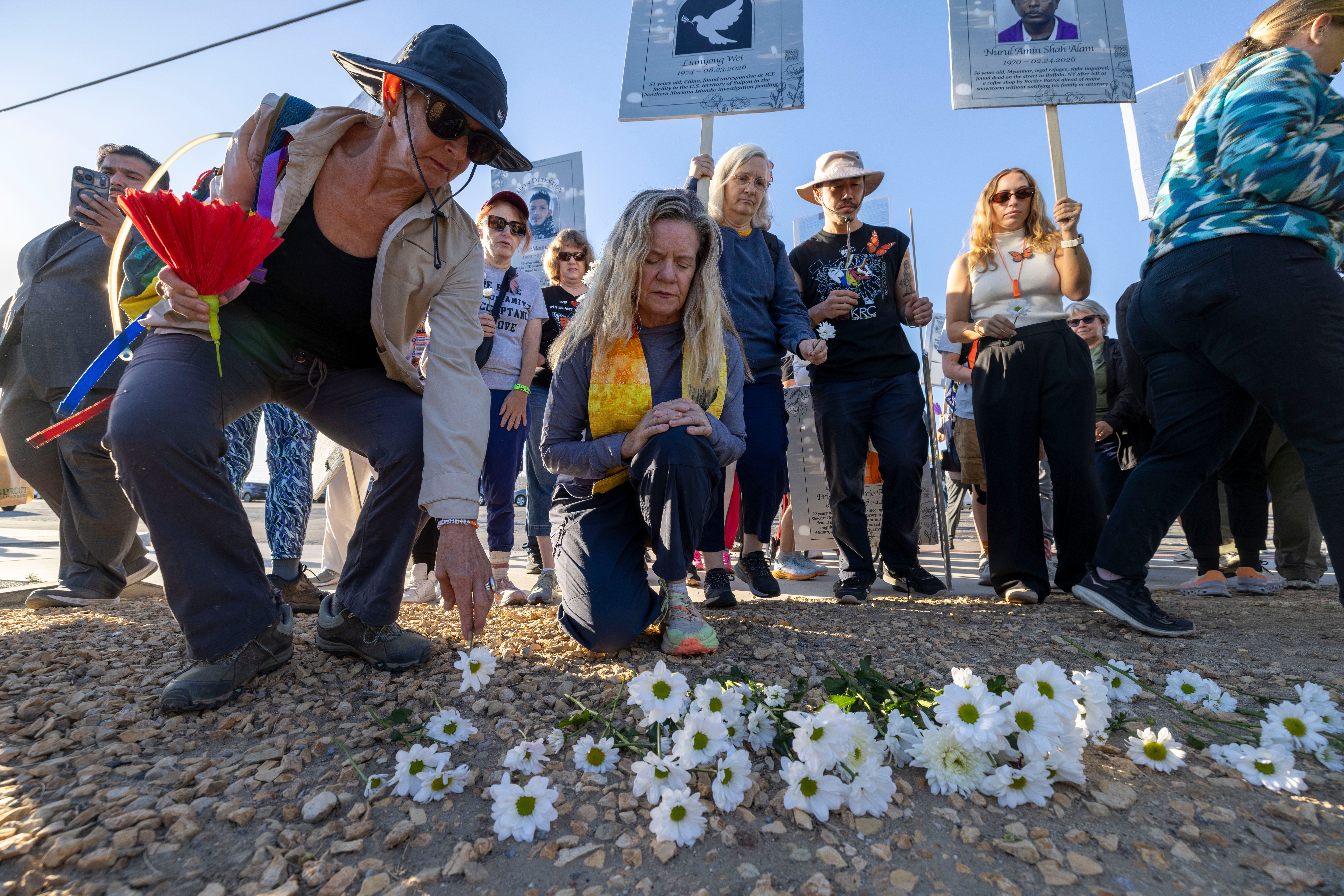 Demonstrators place flowers outside the Adelanto Ice Processing Center in Adelanto, Calif., on Tuesday, Sept. 29, 2026, at the start of a march to the Metropolitan Detention Center Los Angeles, to call for its closure and an end to the inhumane conditions and deaths in detention centers. (AP Photo/Jill Connelly)