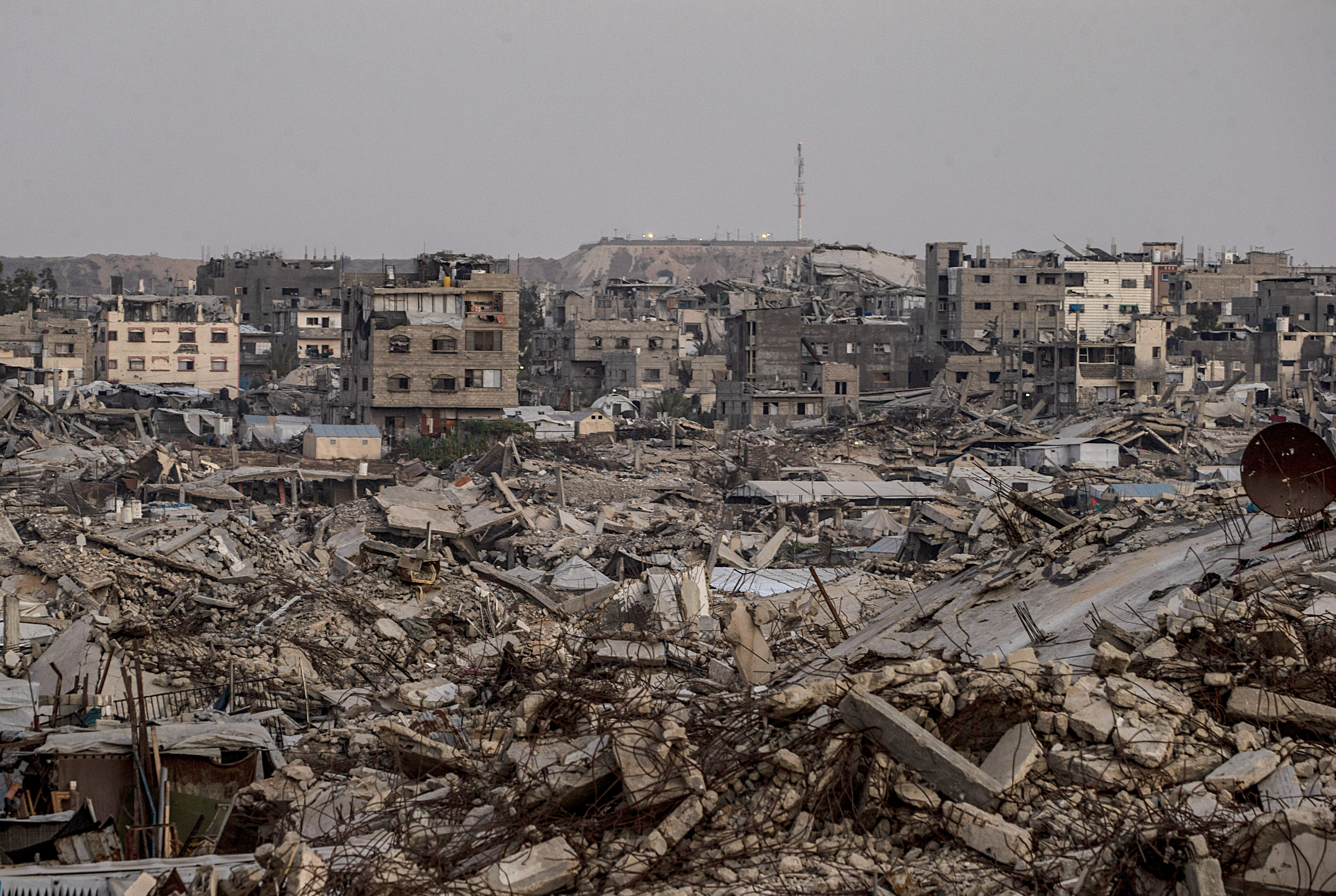 An Israeli military site is seen in the background behind destroyed residential buildings in the Sheikh Radwan neighbourhood in Gaza City, on September 10, 2026