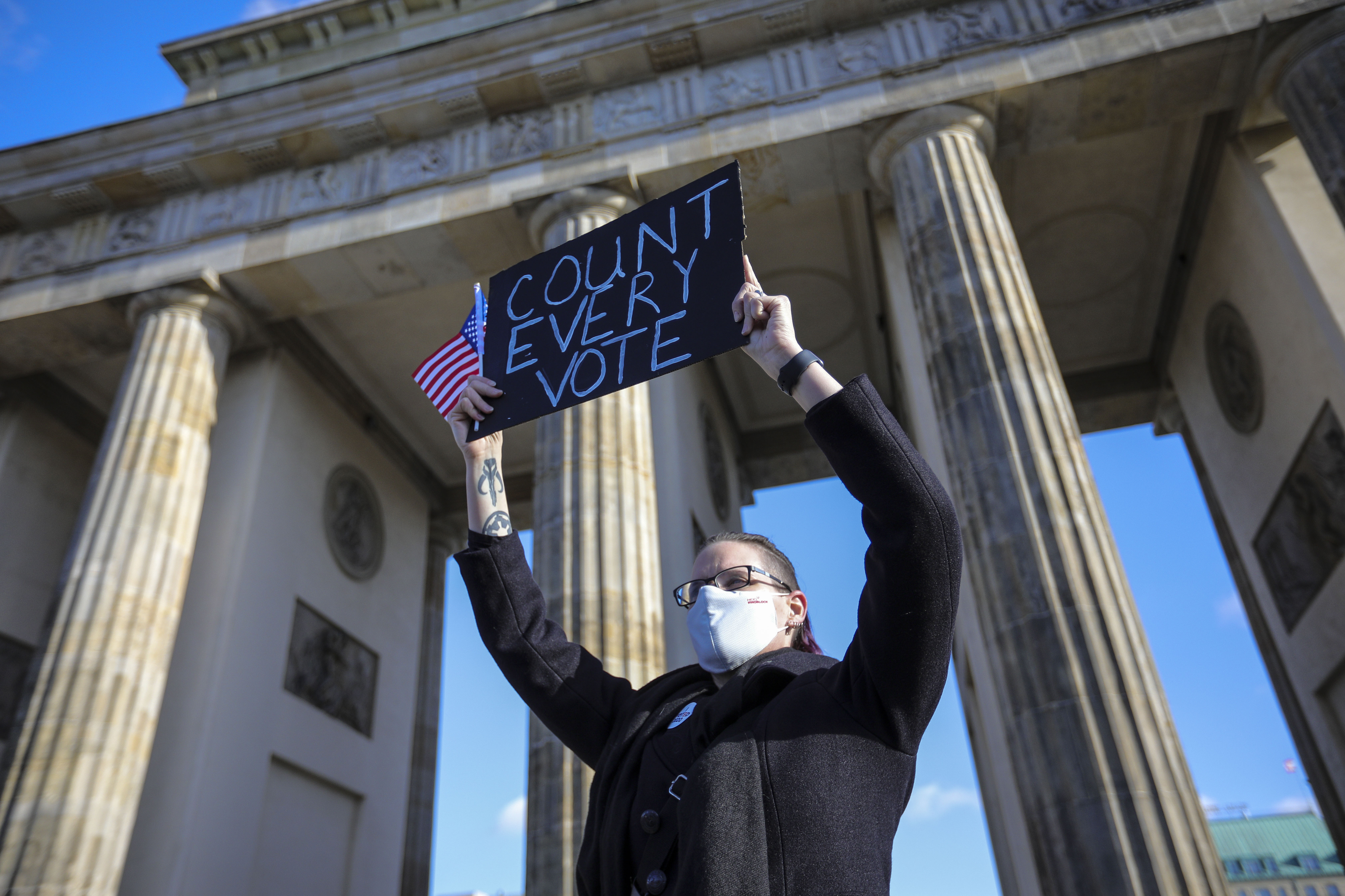 A protester holds a banner reading ‘Count every vote’ as supporters of Democrats Abroad rally near the US Embassy in Berlin, Germany, on November 4, 2020,