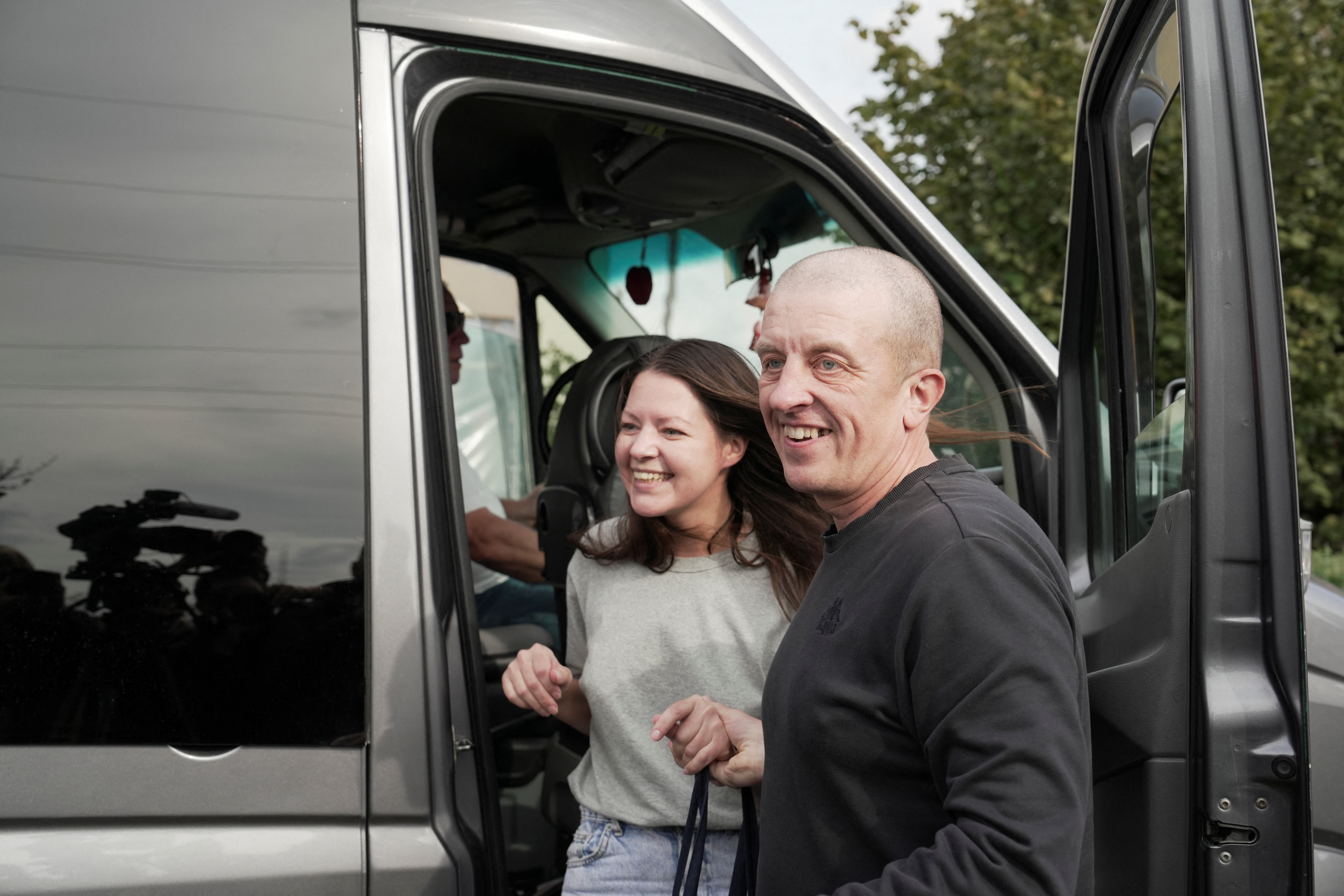 Andrei Alyaksandrau, a prisoner released from Belarus, steps out of a van after his arrival in Vilnius, Lithuania, September 16, 2026. REUTERS/Janis Laizans