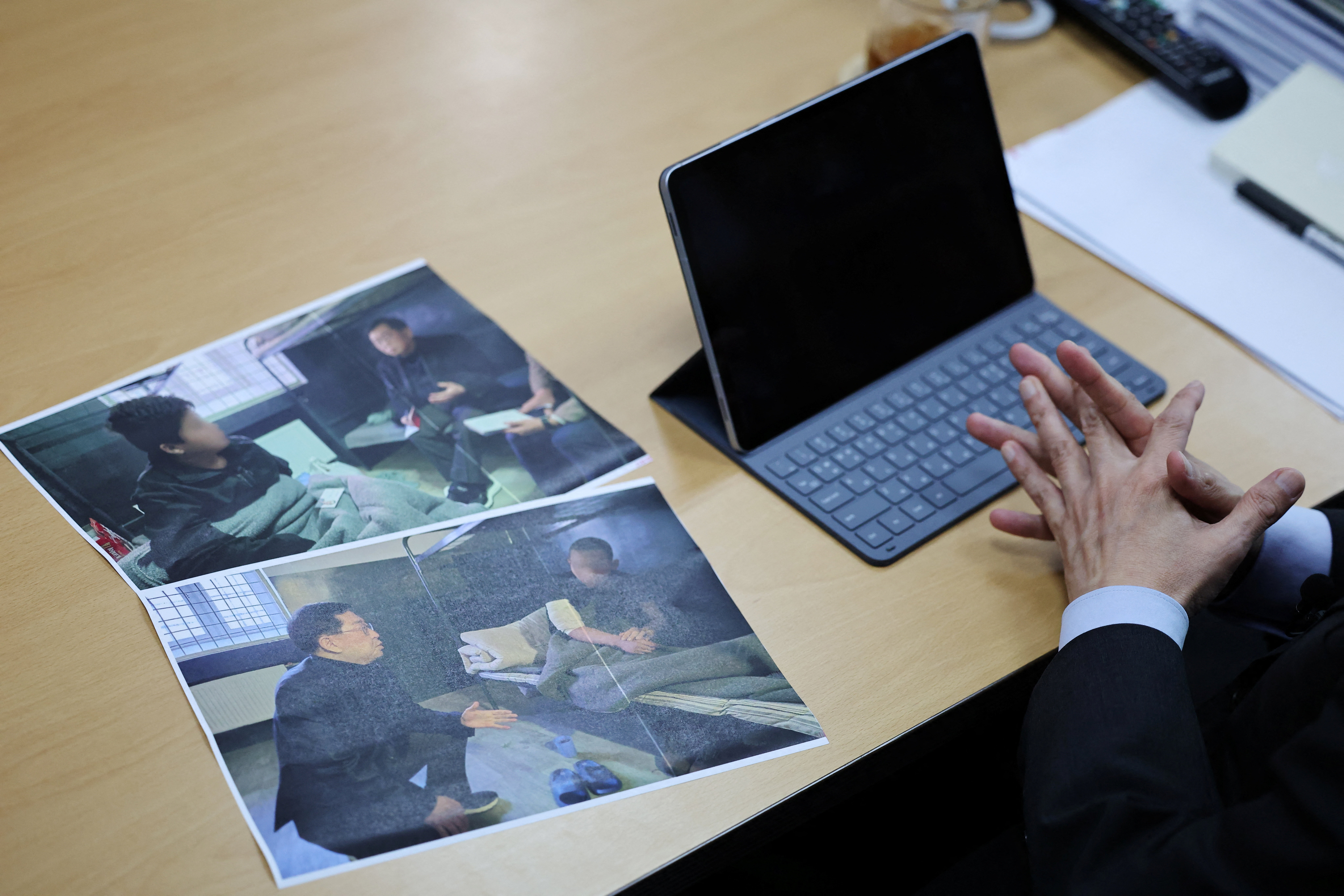 Lawmaker Yu Yong-weon of South Korea’s main opposition People Power Party explains pictures, showing two North Korean POWs who were recently transferred from Ukraine to South Korea, taken during his visit to a POW camp in Ukraine last February, at his office at the National Assembly in Seoul, South Korea, September 28, 2026. Face of POWs are blurred due to security reason by the source. REUTERS/Kim Hong-Ji