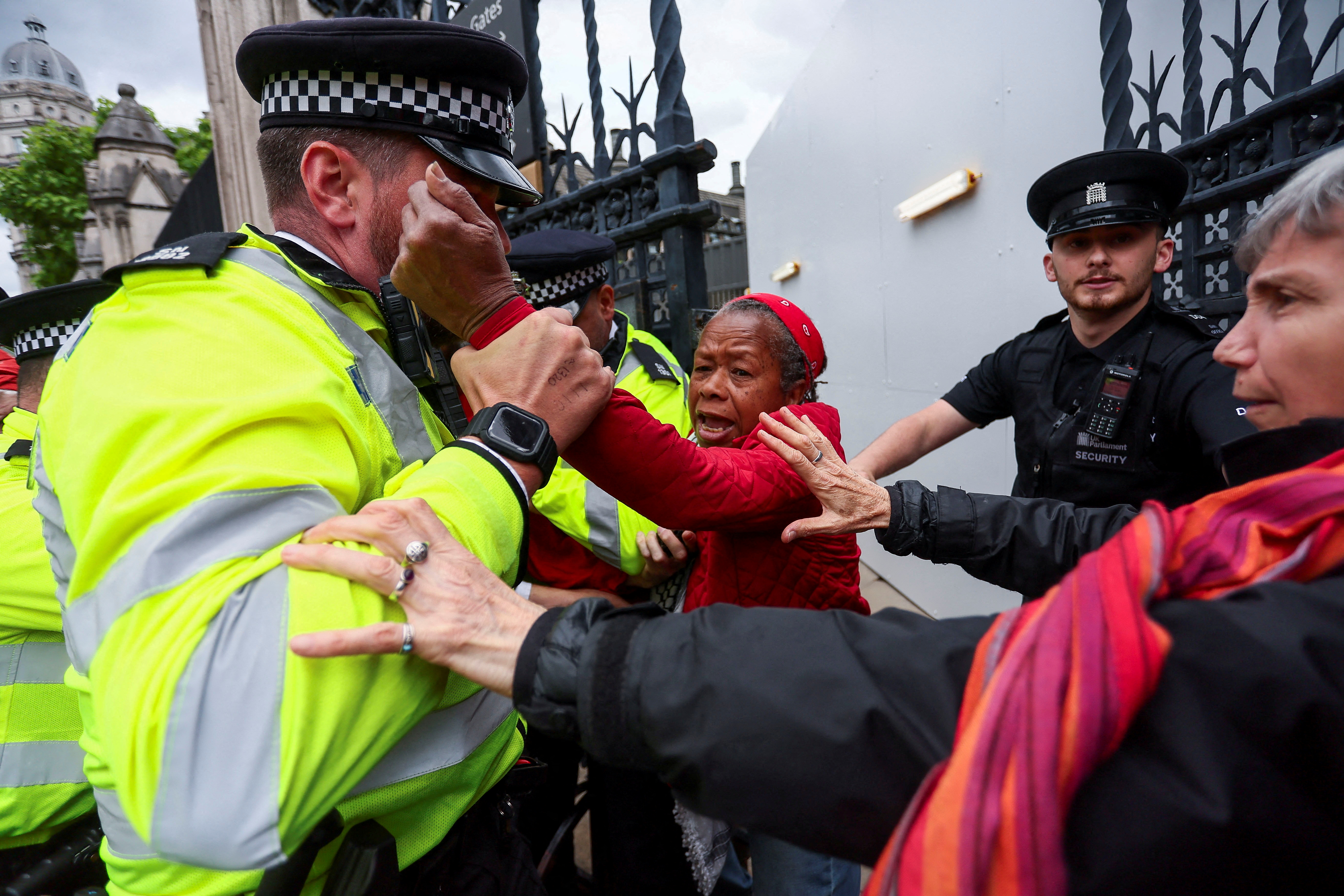 A police officer holds a Pro-Palestinian protester on the day of a demonstration outside the Parliament, organised by campaign groups including Palestine Solidarity Campaign, Avaaz and Parents for Palestine, calling for sanctions on Israel over ongoing hunger among Gaza's war-struck population, in London, Britain, June 4, 2025. REUTERS/Isabel Infantes TPX IMAGES OF THE DAY