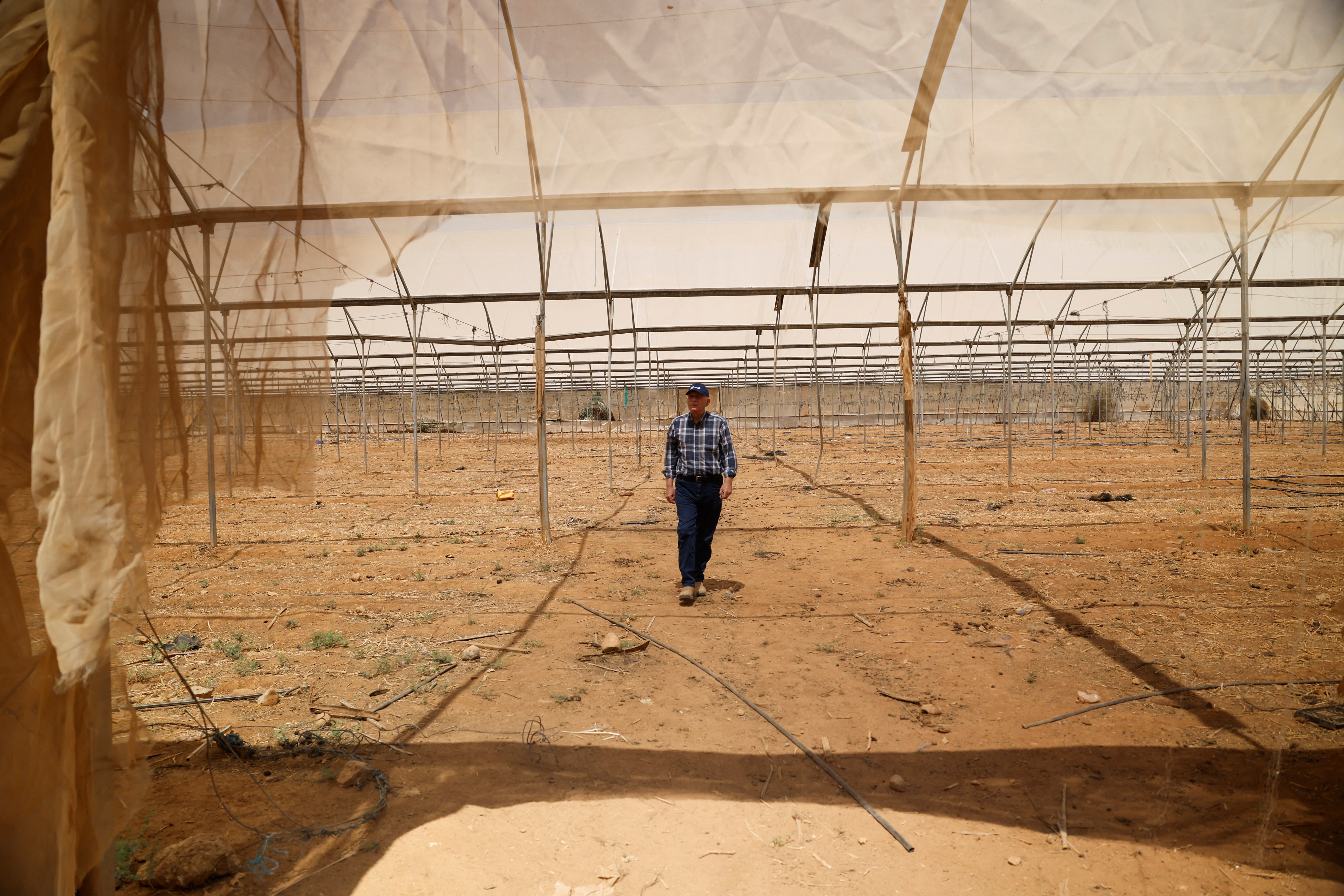 Saad Nemer, a Palestinian landowner who says that Israeli settlers diverted water from his land making it impossible to plant crops, visits his arid farm in the Palestinian village Fasayil in the Israeli-occupied West Bank, August 9, 2026. REUTERS/Mohamad Torokman