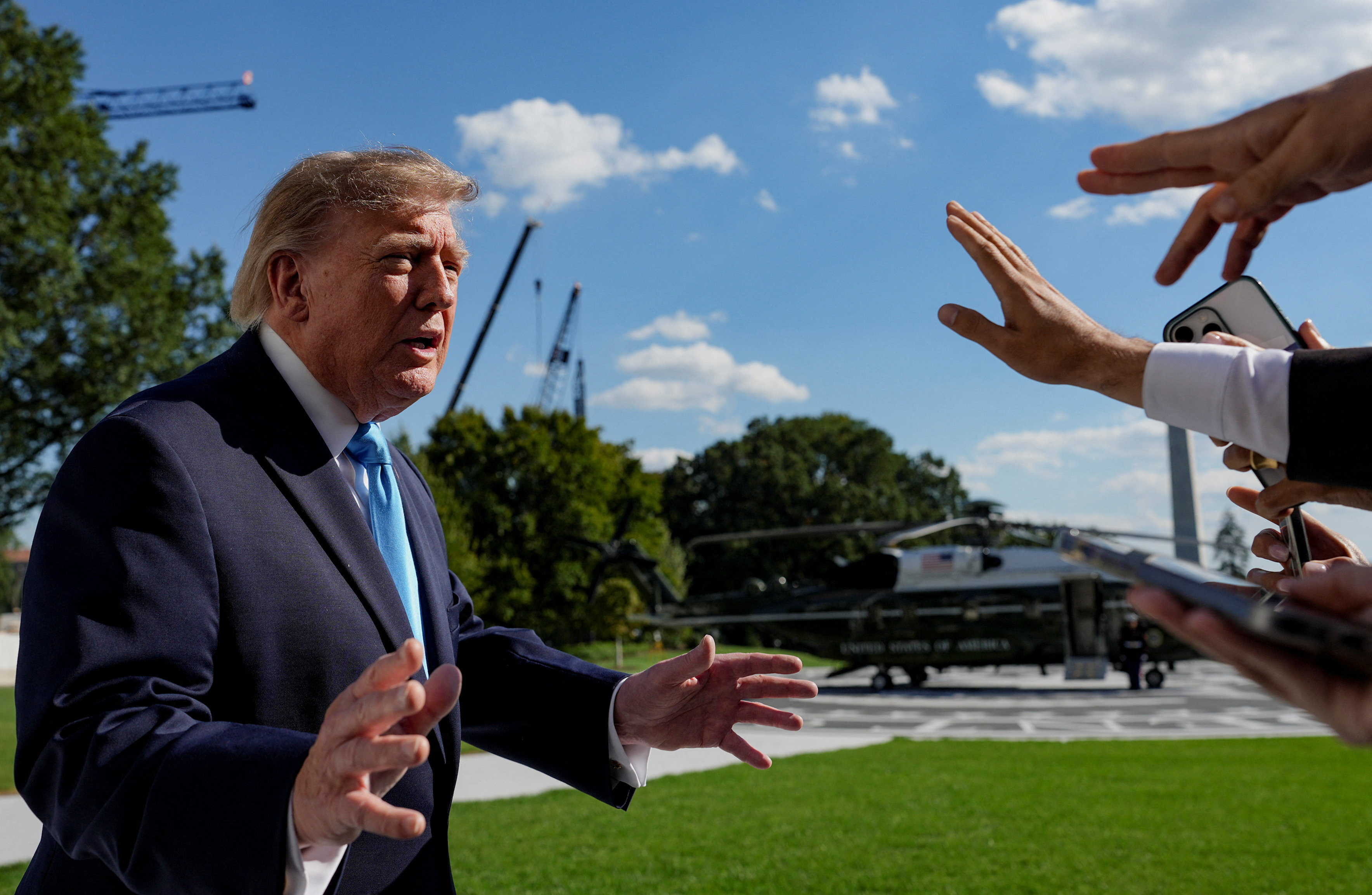US President Donald Trump speaks with media before boarding Marine One as he travels to Grand Island, Nebraska, on the South Lawn of the White House in Washington, DC, US, October 5, 2026 [Eric Lee/Reuters]