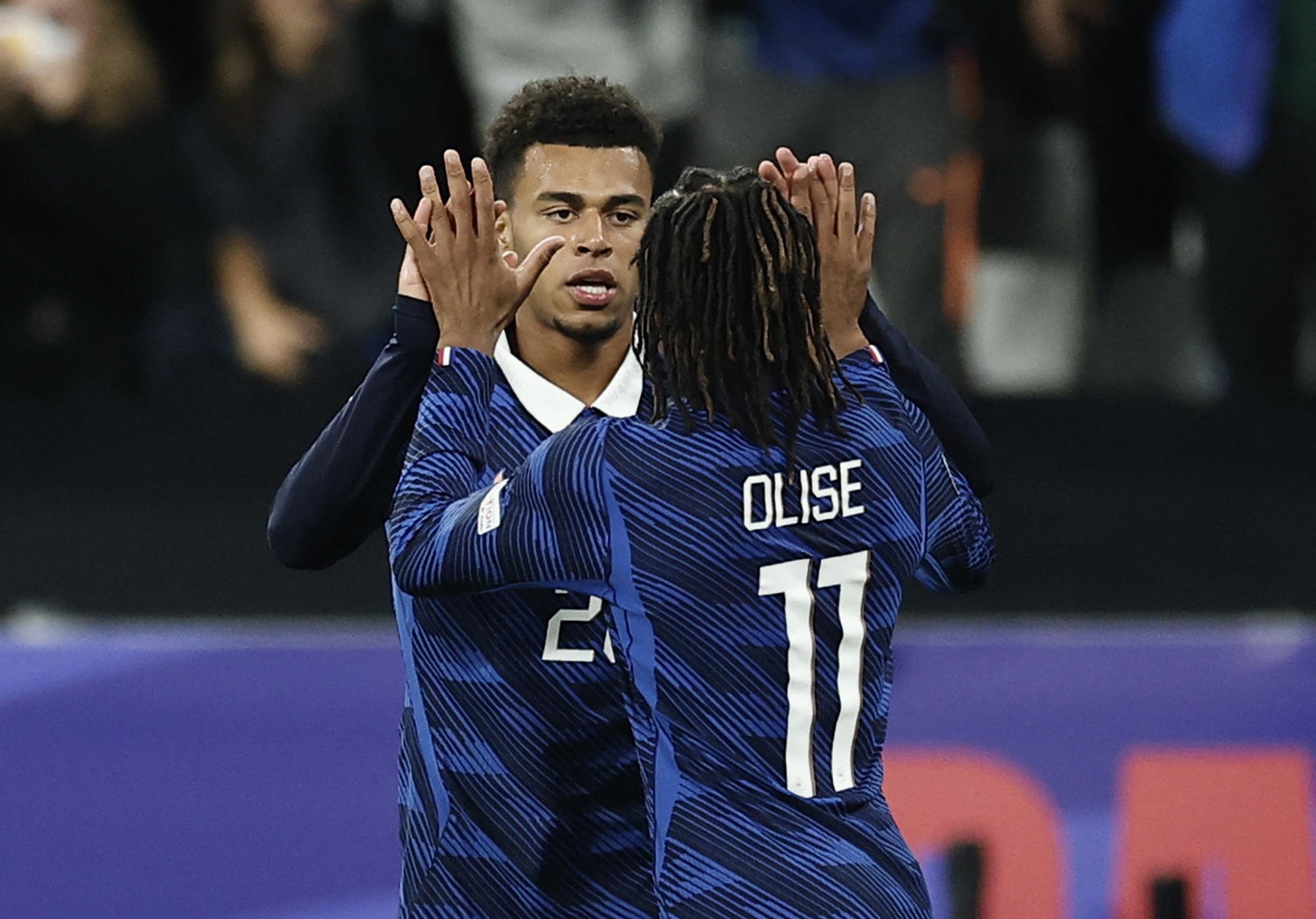 France's Desire Doue celebrates scoring their first goal with Michael Olise {Benoit Tessier/Reuters}