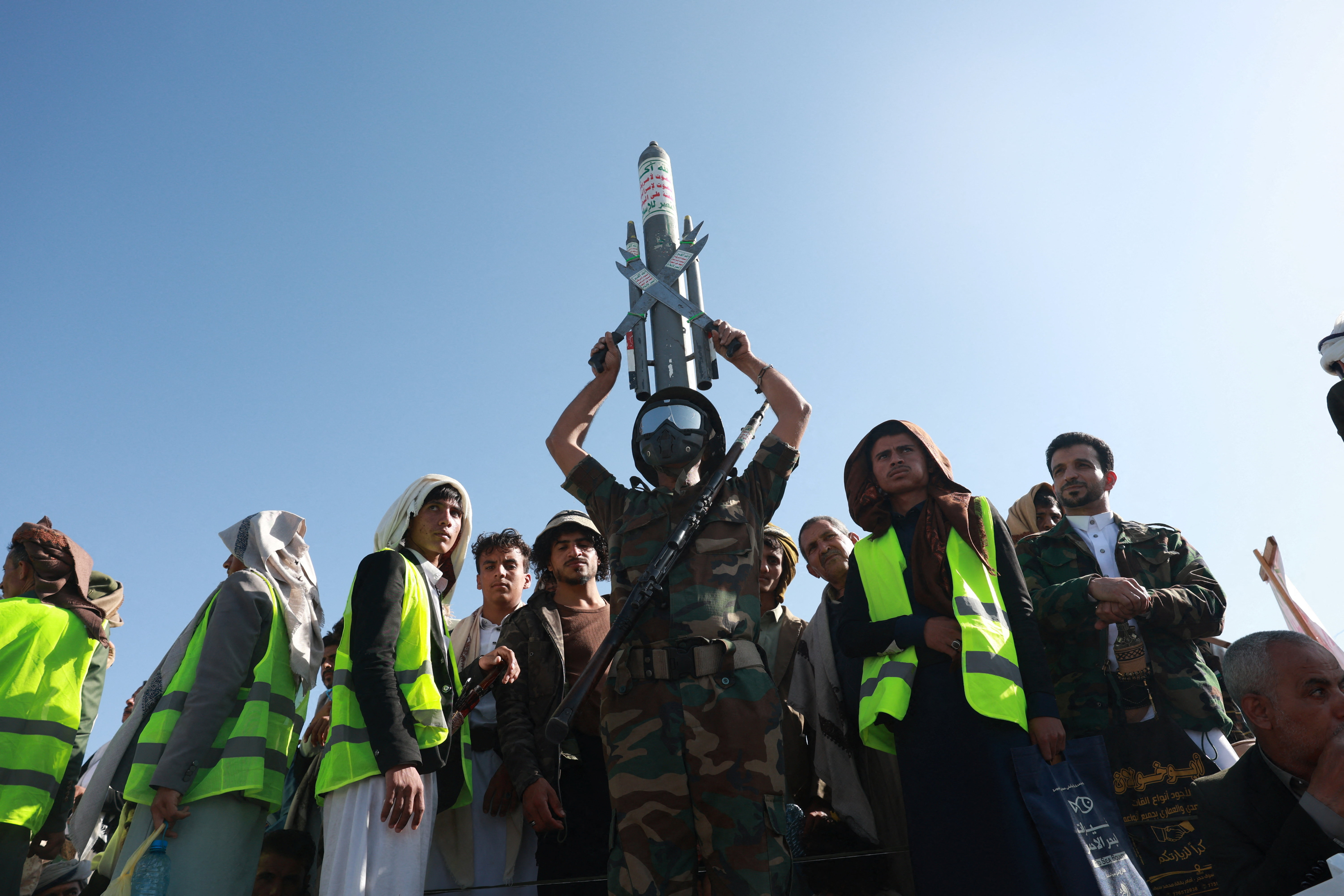 A Houthi supporter wearing a military uniform holds a mock missile at a rally to show support to the movement in Sanaa, Yemen October 9, 2026. [Mohammed al-Mahdi/Reuters]