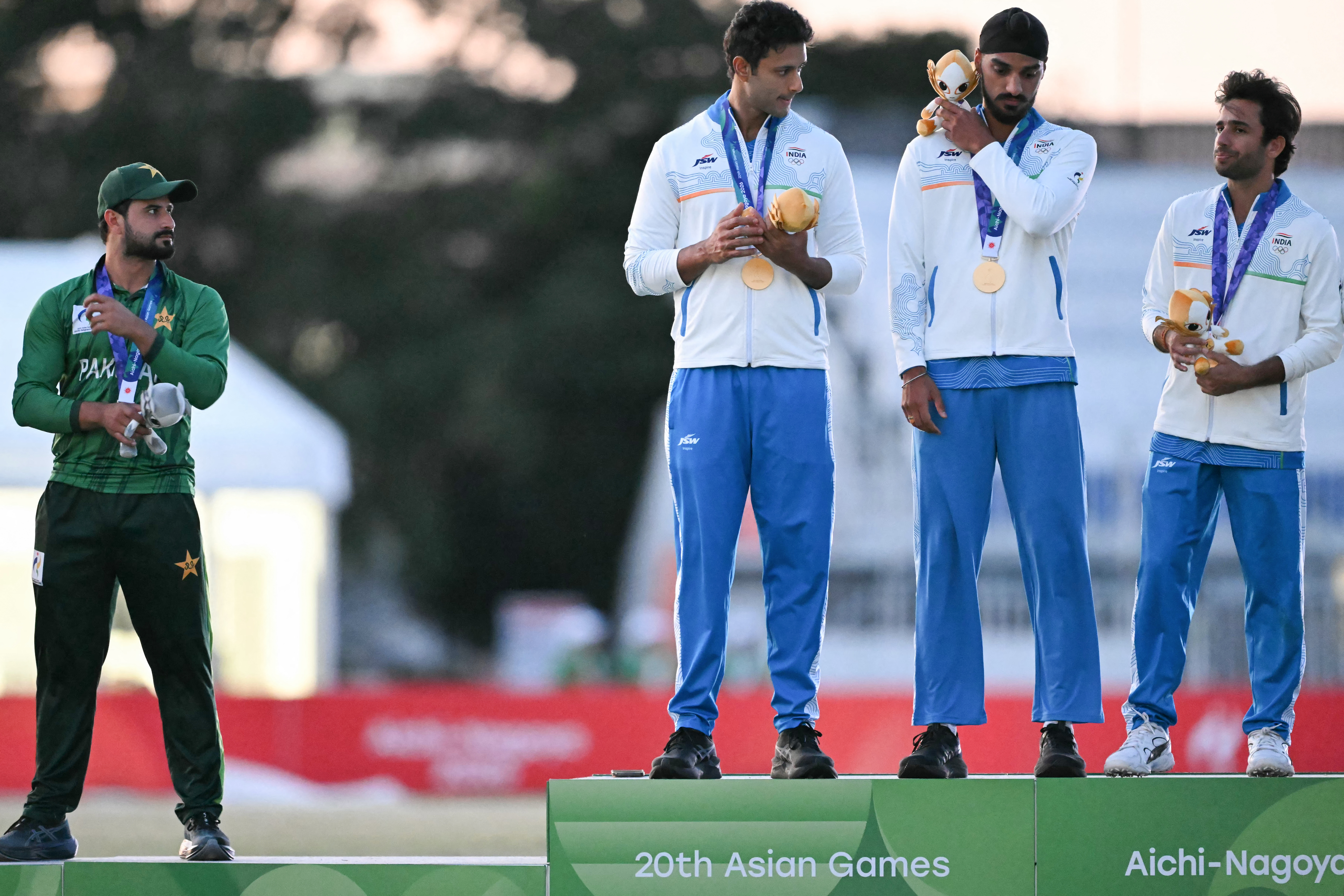 Gold medallists India (R) and silver medallists Pakistan (L) stand on the podium during the victory ceremony for the men's cricket in the 2026 Asian Games at the Korogi Athletic Park in Nisshin on October 3, 2026. (Photo by ANDREW CABALLERO-REYNOLDS / AFP)