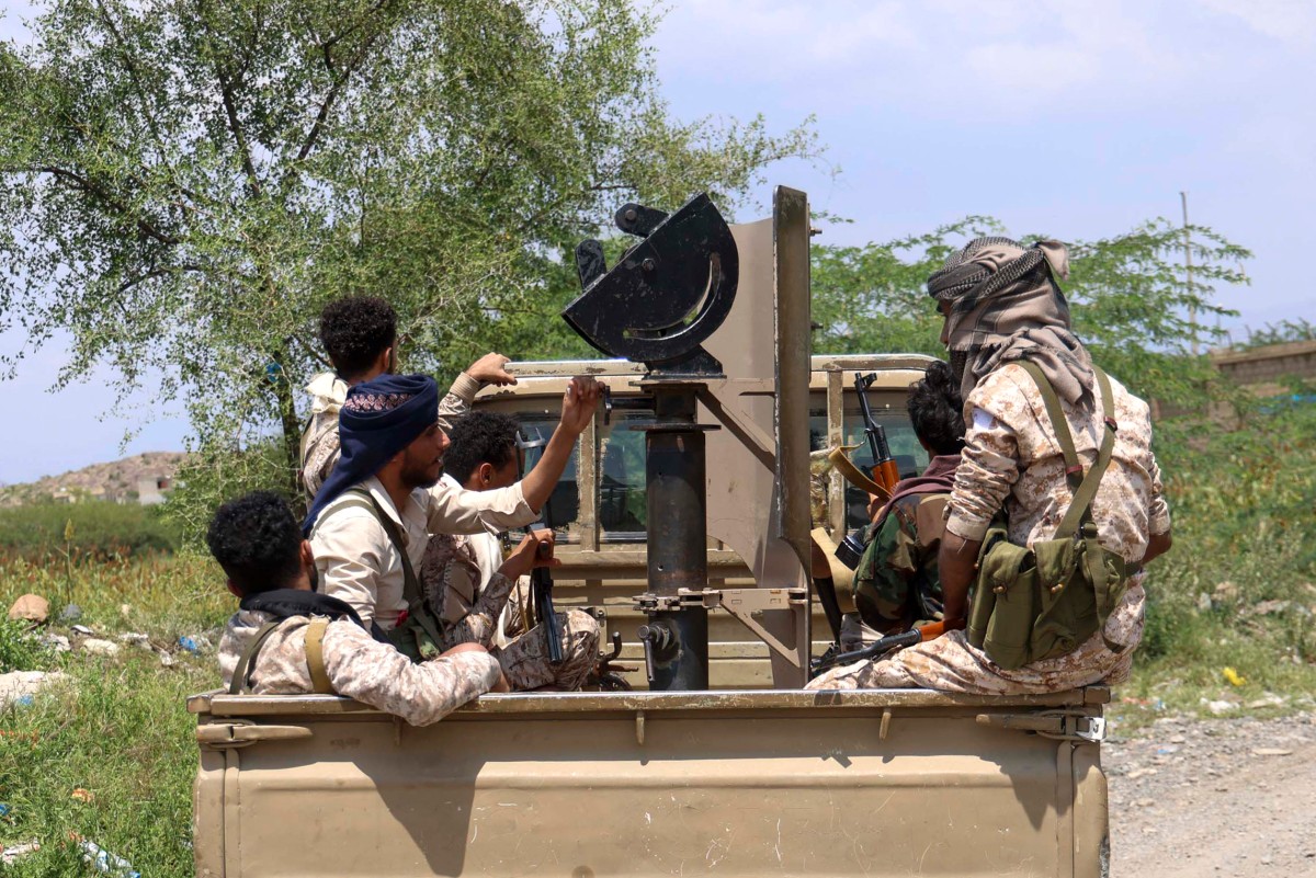 Saudi-backed Yemeni government forces ride in the back of a military truck at the Jabal Han front west of the city of Taiz [Ahmad al-Basha/AFP]