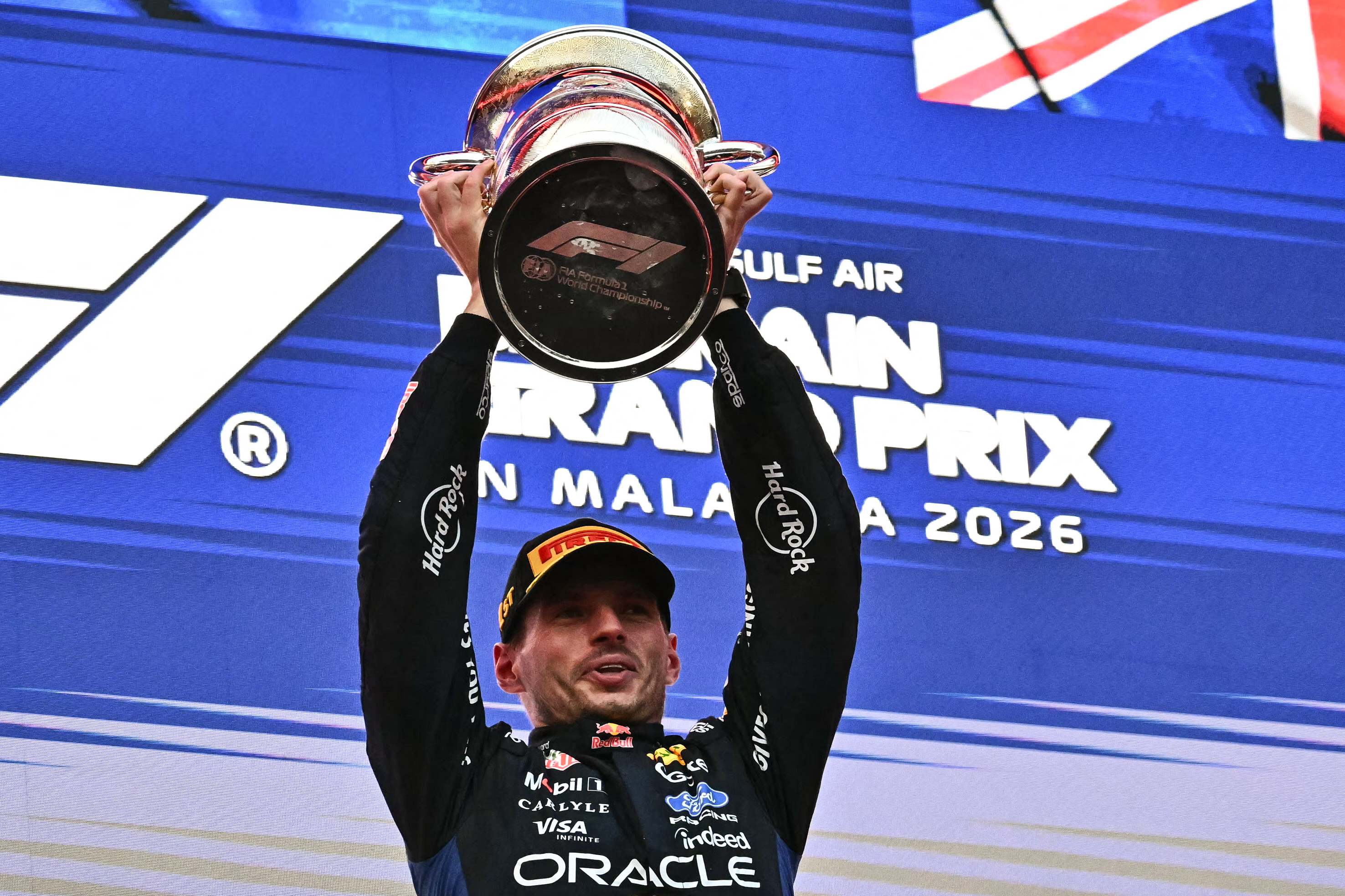 Race winner Red Bull Racing's Dutch driver Max Verstappen lifts his trophy during podium ceremony of the Formula One Bahrain Grand Prix in Sepang on October 4, 2026. (Photo by Lillian SUWANRUMPHA / AFP)