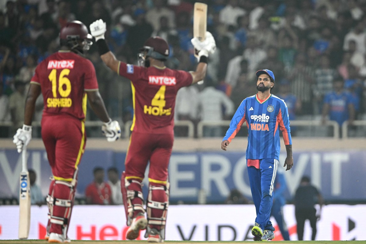 India's captain Shreyas Iyer (R) looks on as West Indies captain Shai Hope (C) celebrates his century (100 runs) and winning the second T20 international cricket match